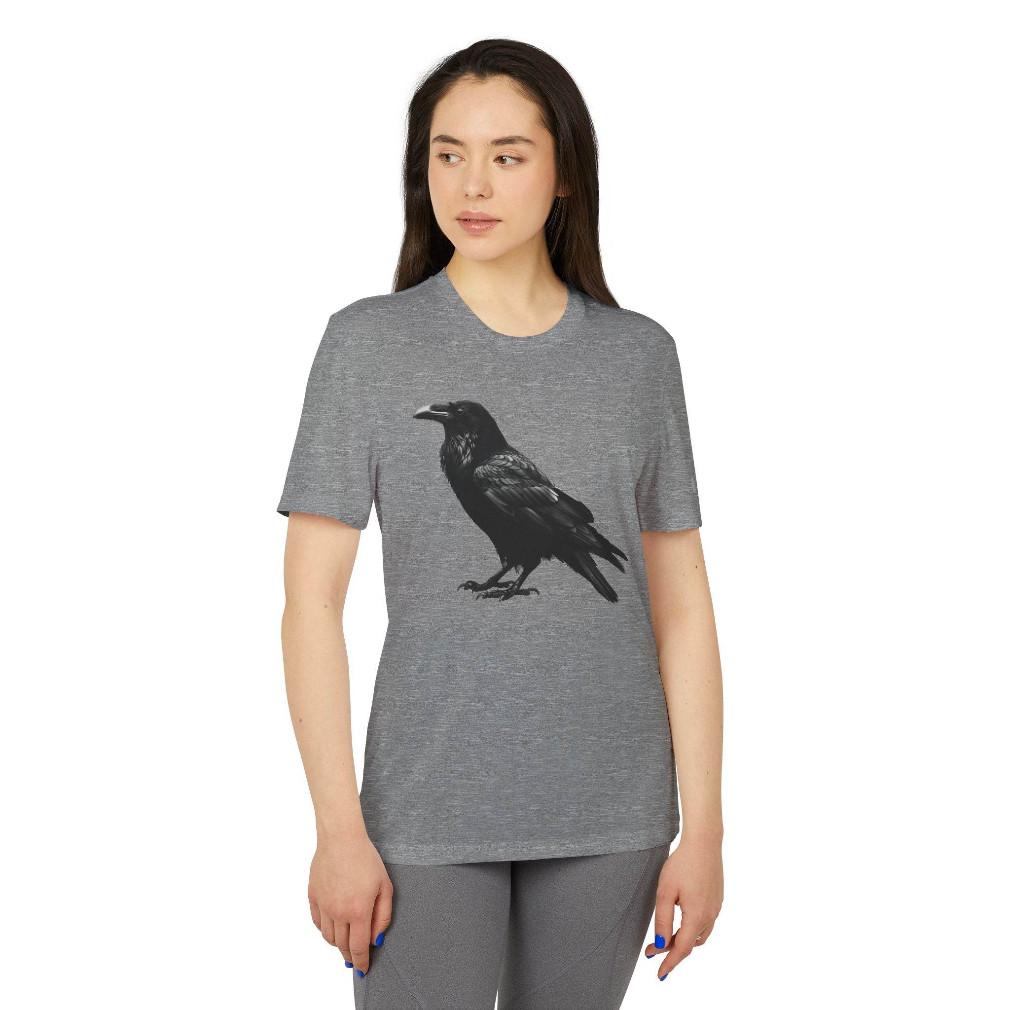 Woman wearing a gray eco-friendly Adidas sport t-shirt with a black raven graphic print