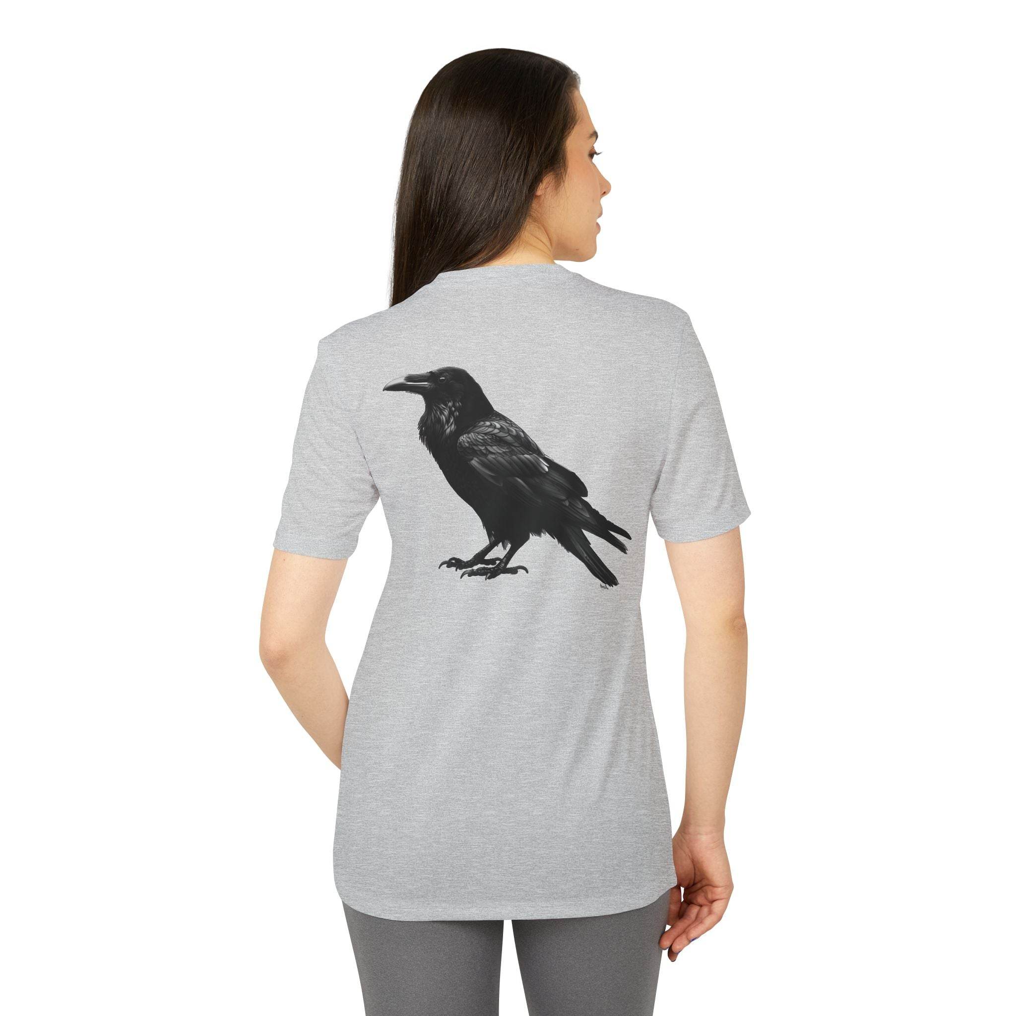 Woman wearing a Printify eco-friendly Adidas sport t-shirt with black raven graphic on back