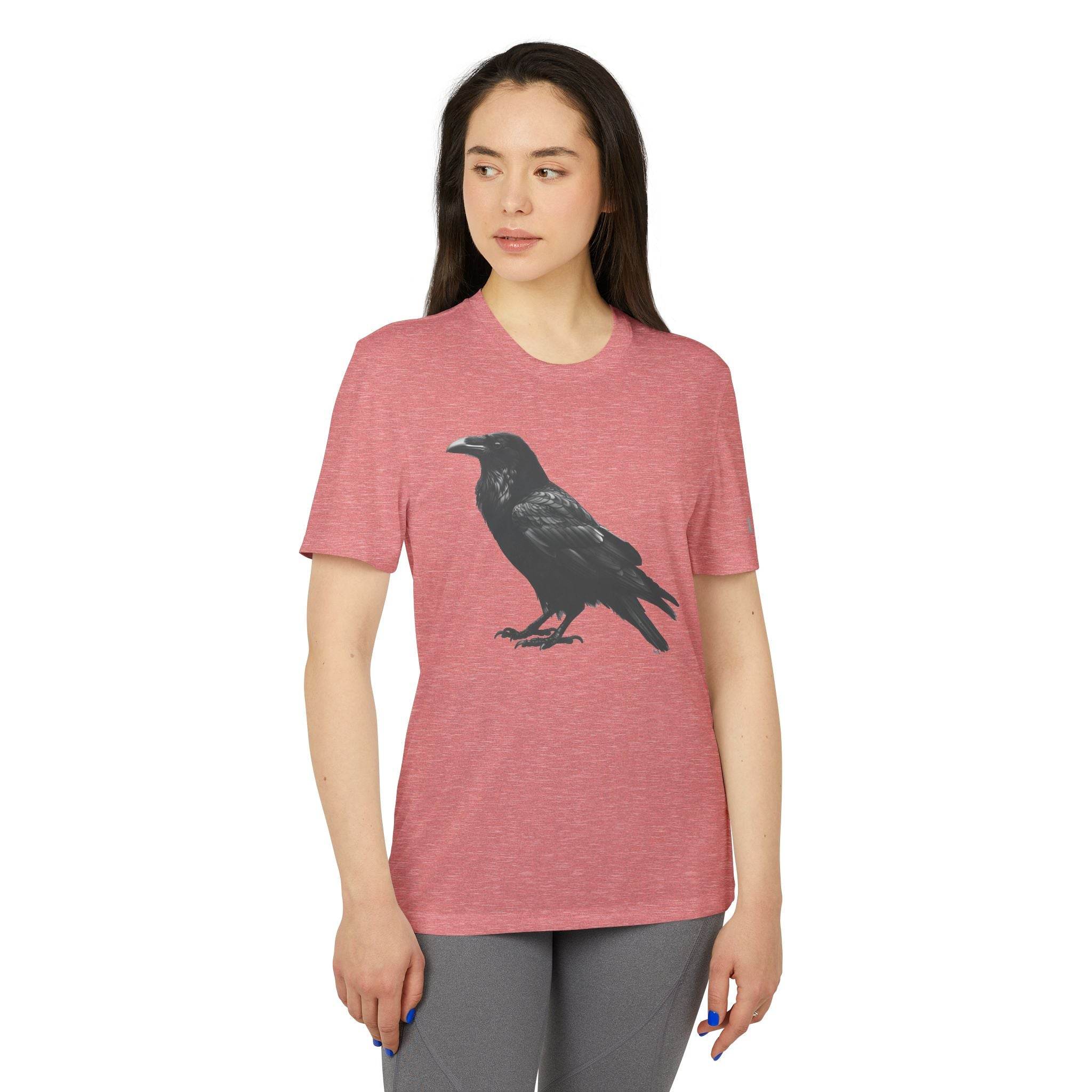 Woman wearing a pink eco-friendly Adidas sport t-shirt with a black crow graphic printed on the front