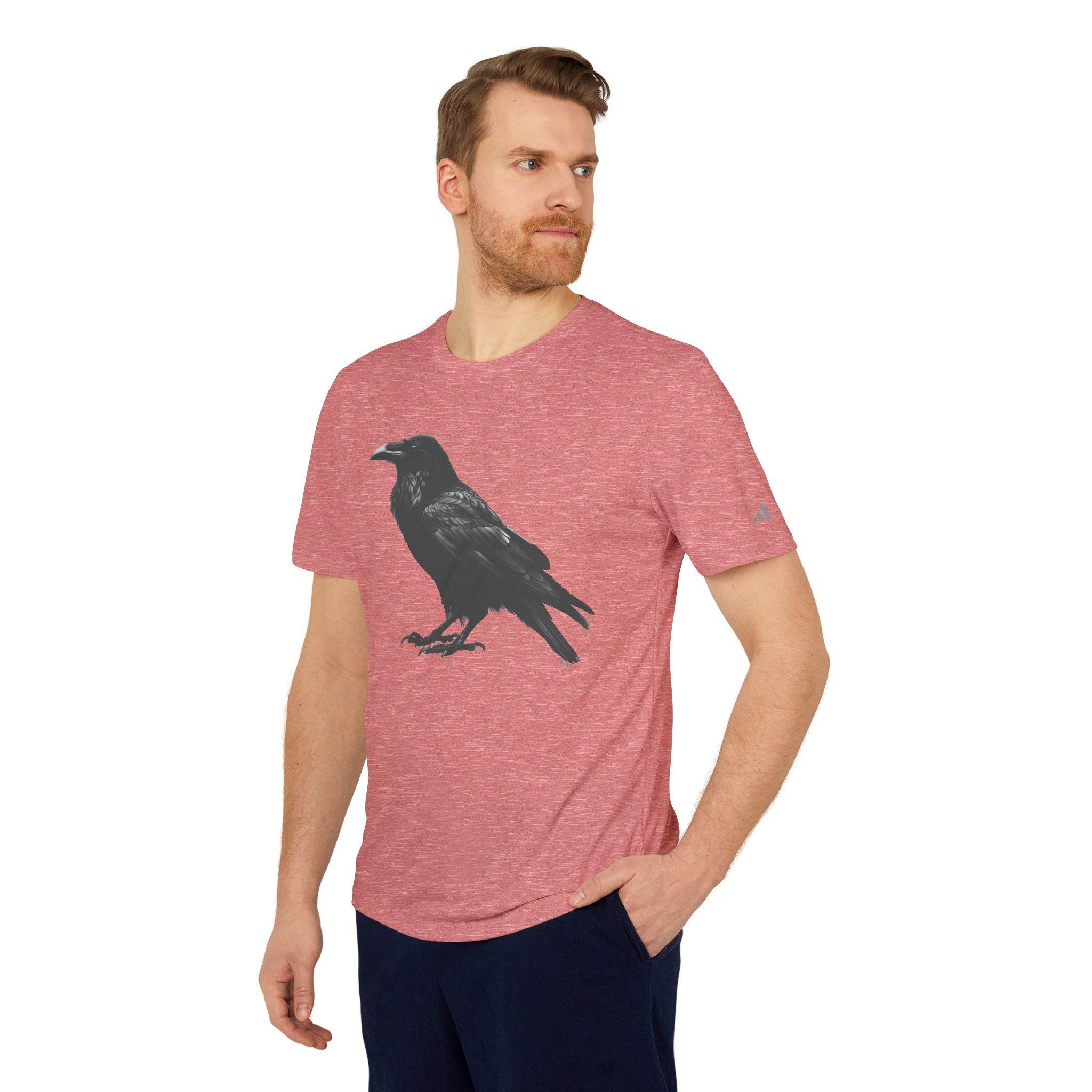 Man wearing a Printify eco-friendly Adidas sport t-shirt in red with a black crow graphic