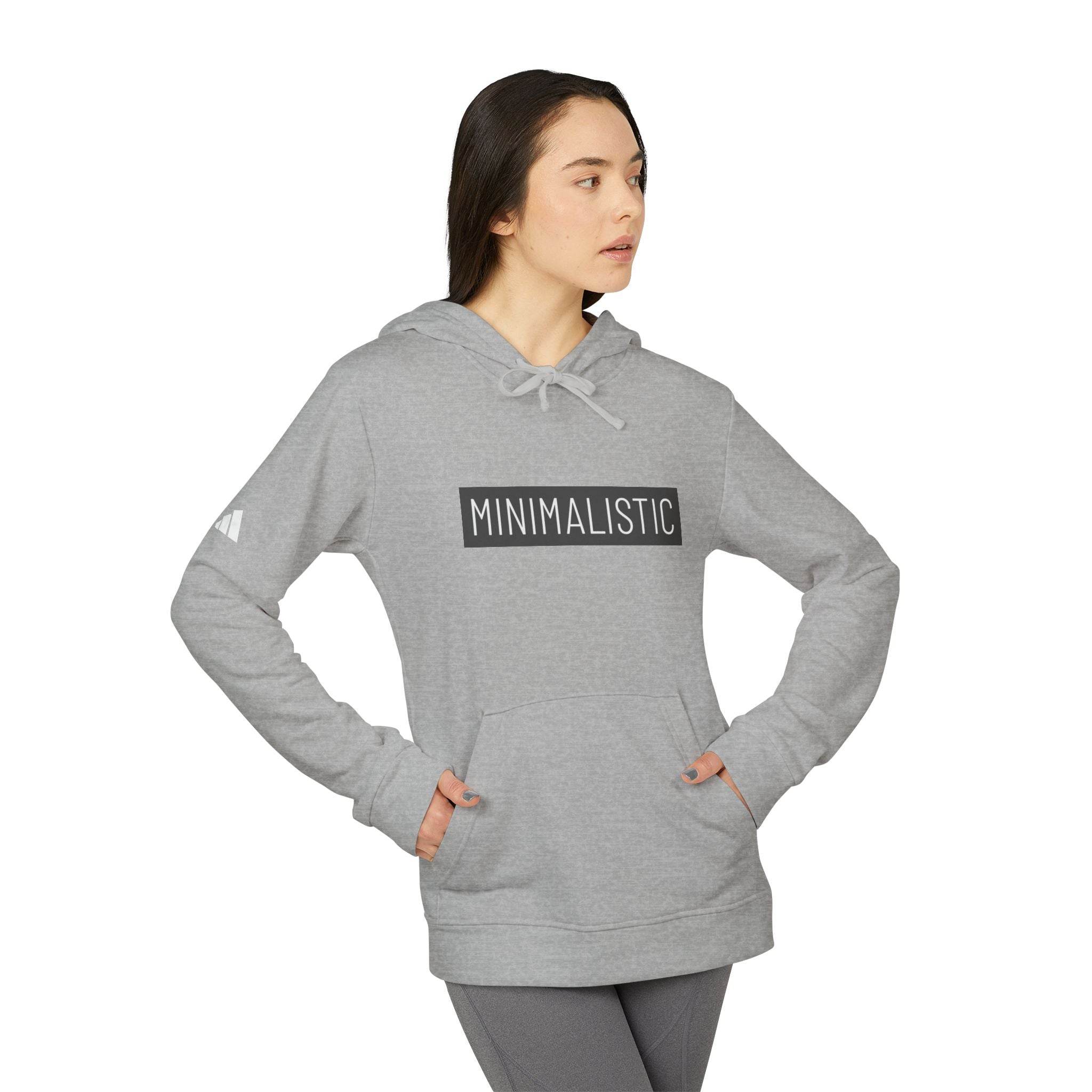 Printify gray eco-friendly unisex hoodie with minimalist graphic worn by woman with hands in pockets