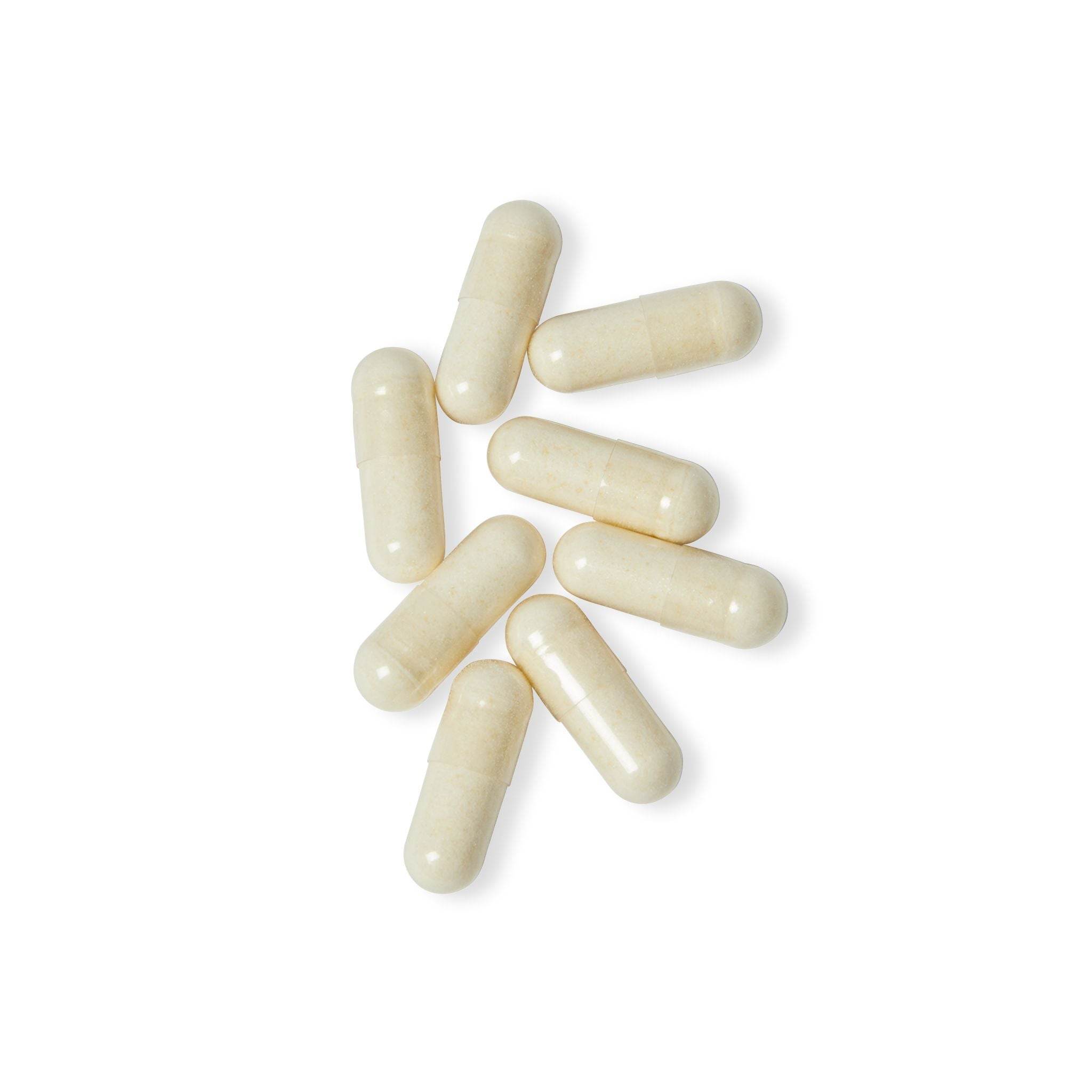 White BioFlora probiotic capsules scattered on a white background for digestive health