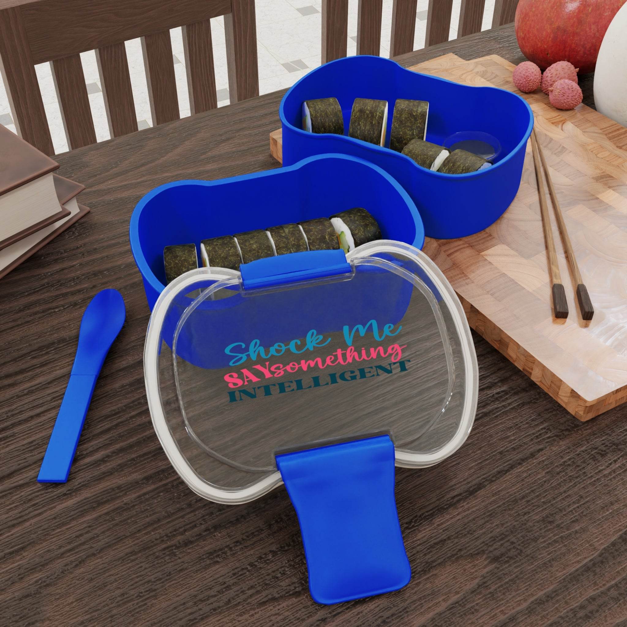 Printify reusable lunch container in blue with sushi compartments and a matching blue spoon on a wooden table