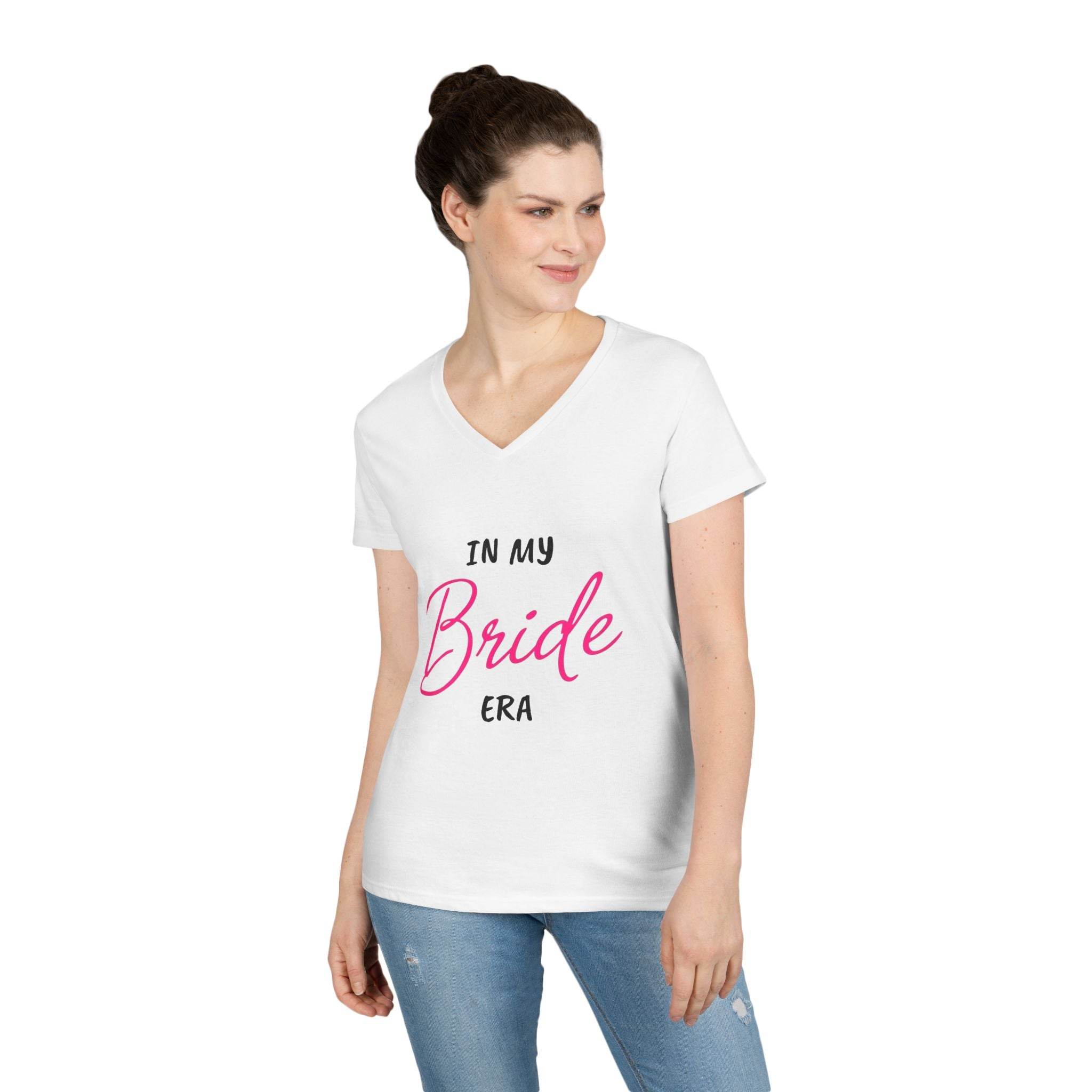 Printify white v neck women t shirt reading In My Bride Era worn by model with jeans eco-friendly bride t-shirt