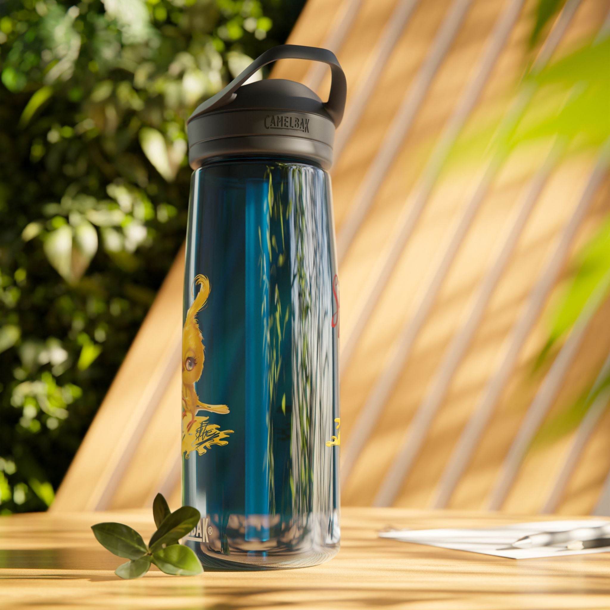 Printify eco-friendly water bottle with black lid placed on wooden table against green leafy background
