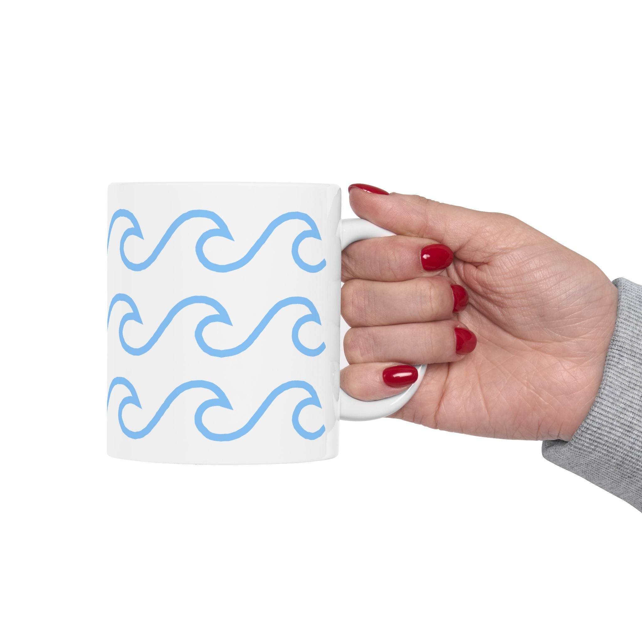 White ceramic mug with wave pattern in light blue held by hand with red nails from Printify