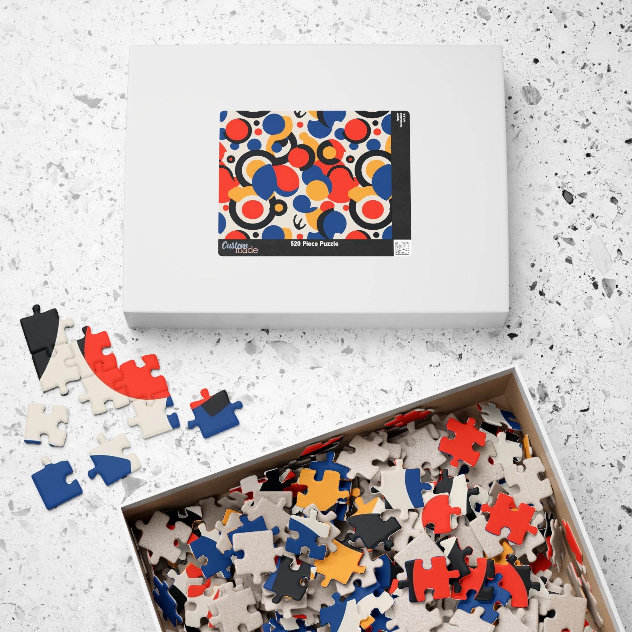 Colorful eco puzzle by Printify with abstract vibrant pieces in blue red black and beige in a box