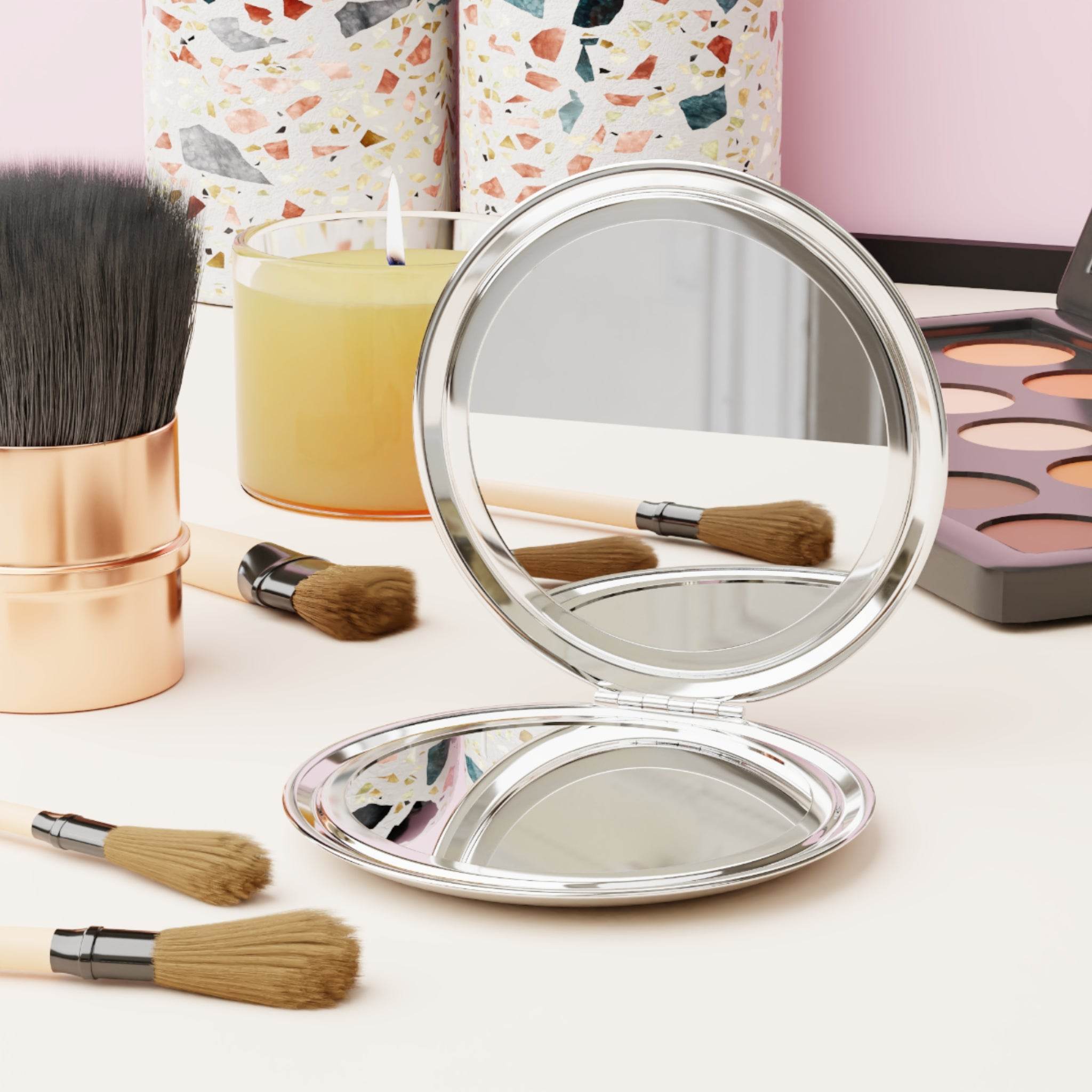 personalized compact travel mirror open on vanity with makeup brushes eyeshadow palette candle