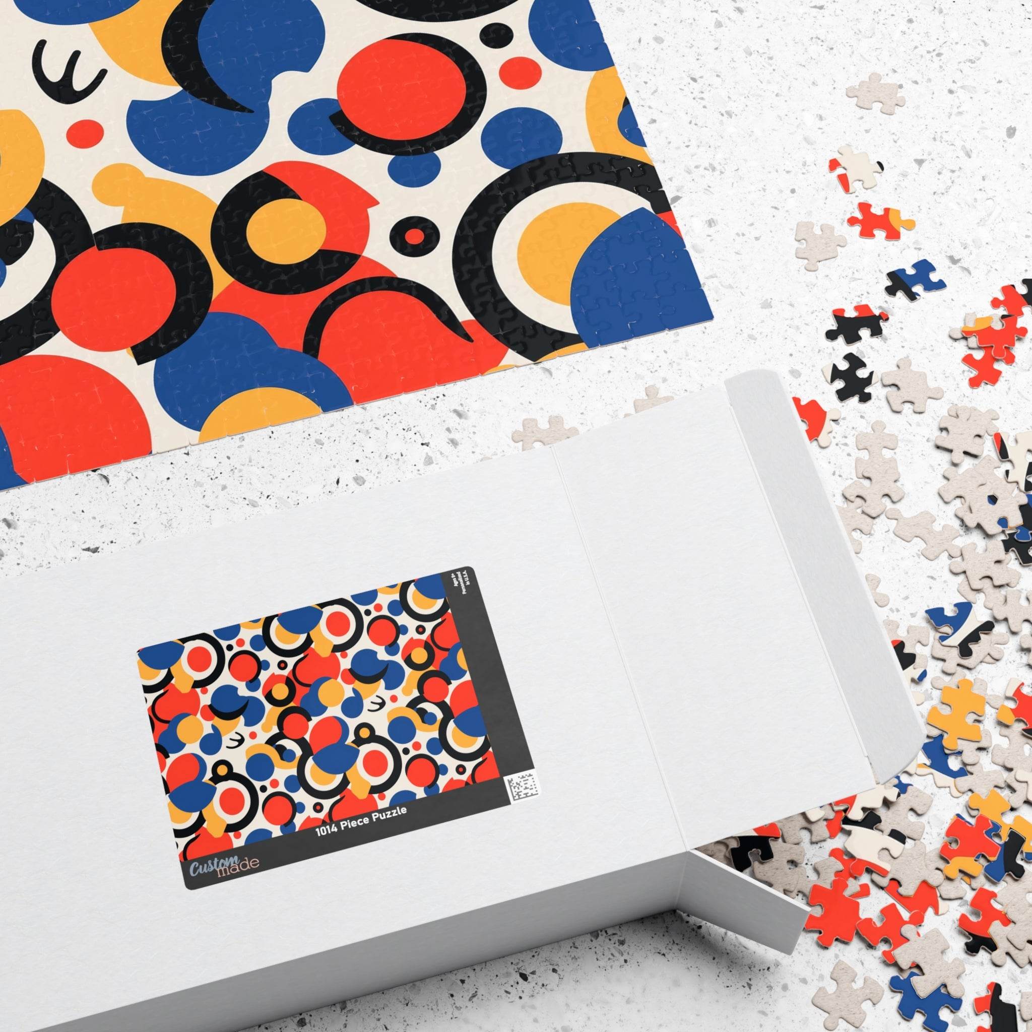Printify colorful eco puzzle with abstract circular patterns partially assembled next to its open white box