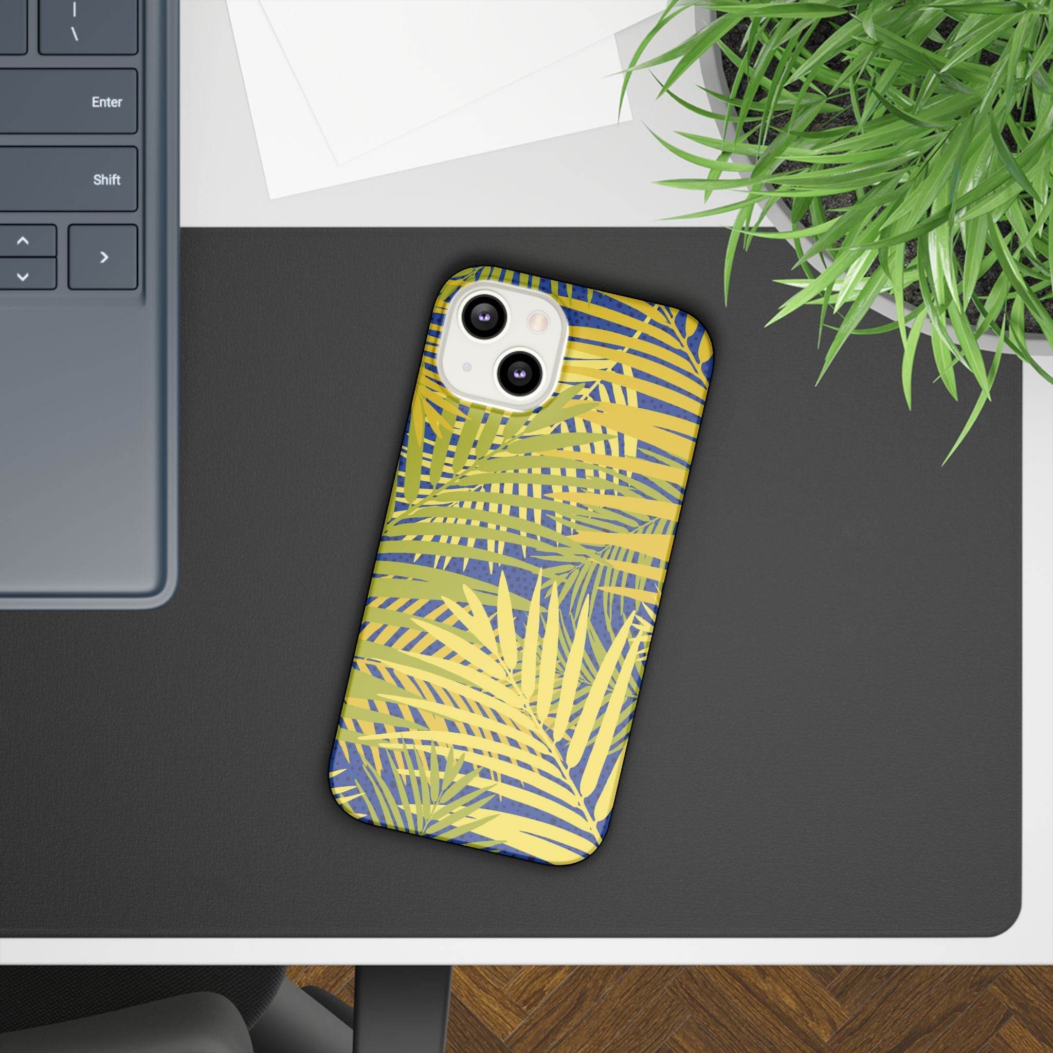 Printify sustainable slim phone cover with yellow and green tropical leaf design on a smartphone