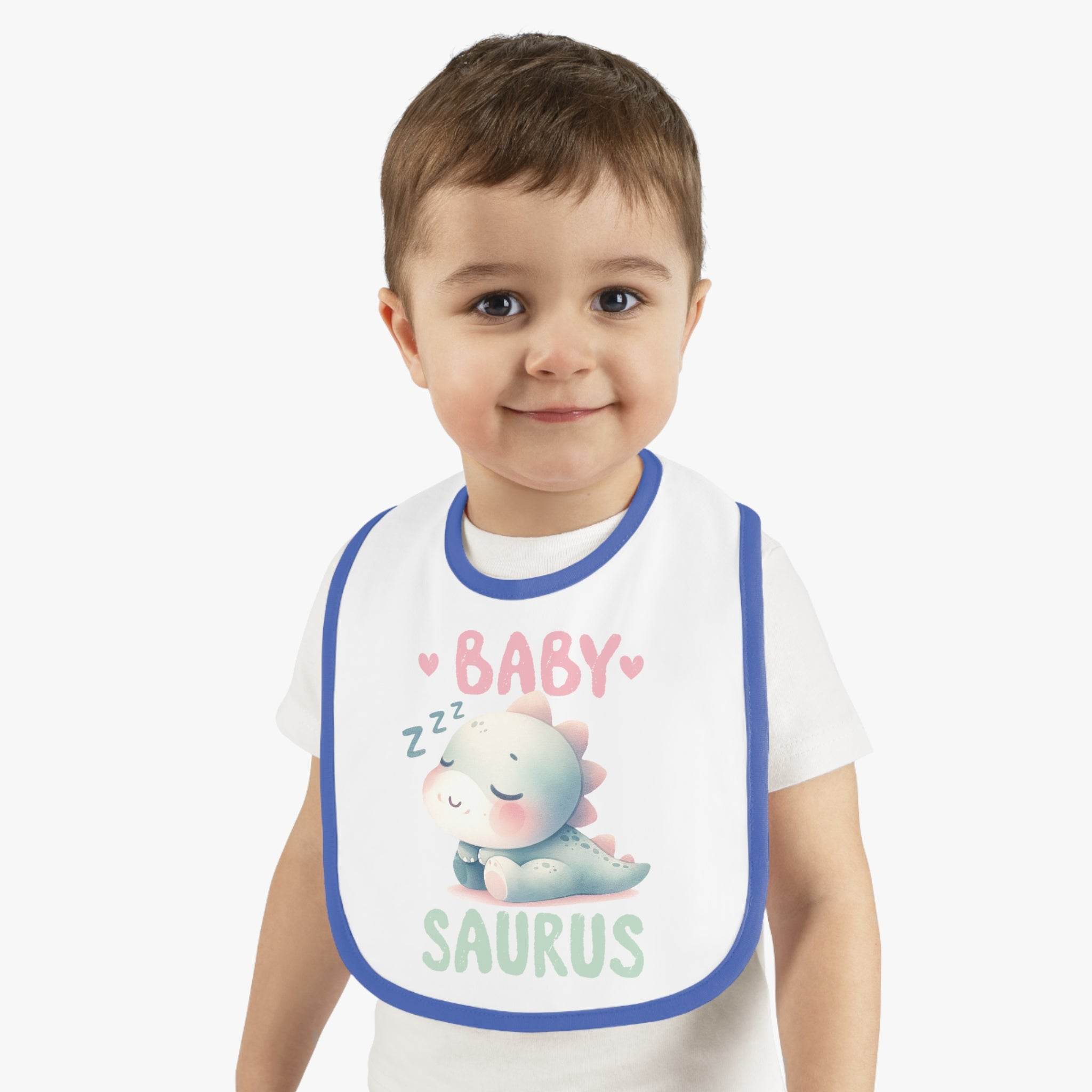 Toddler wearing a dinosaur print baby bib with a cute sleeping dinosaur and blue trim from Printify