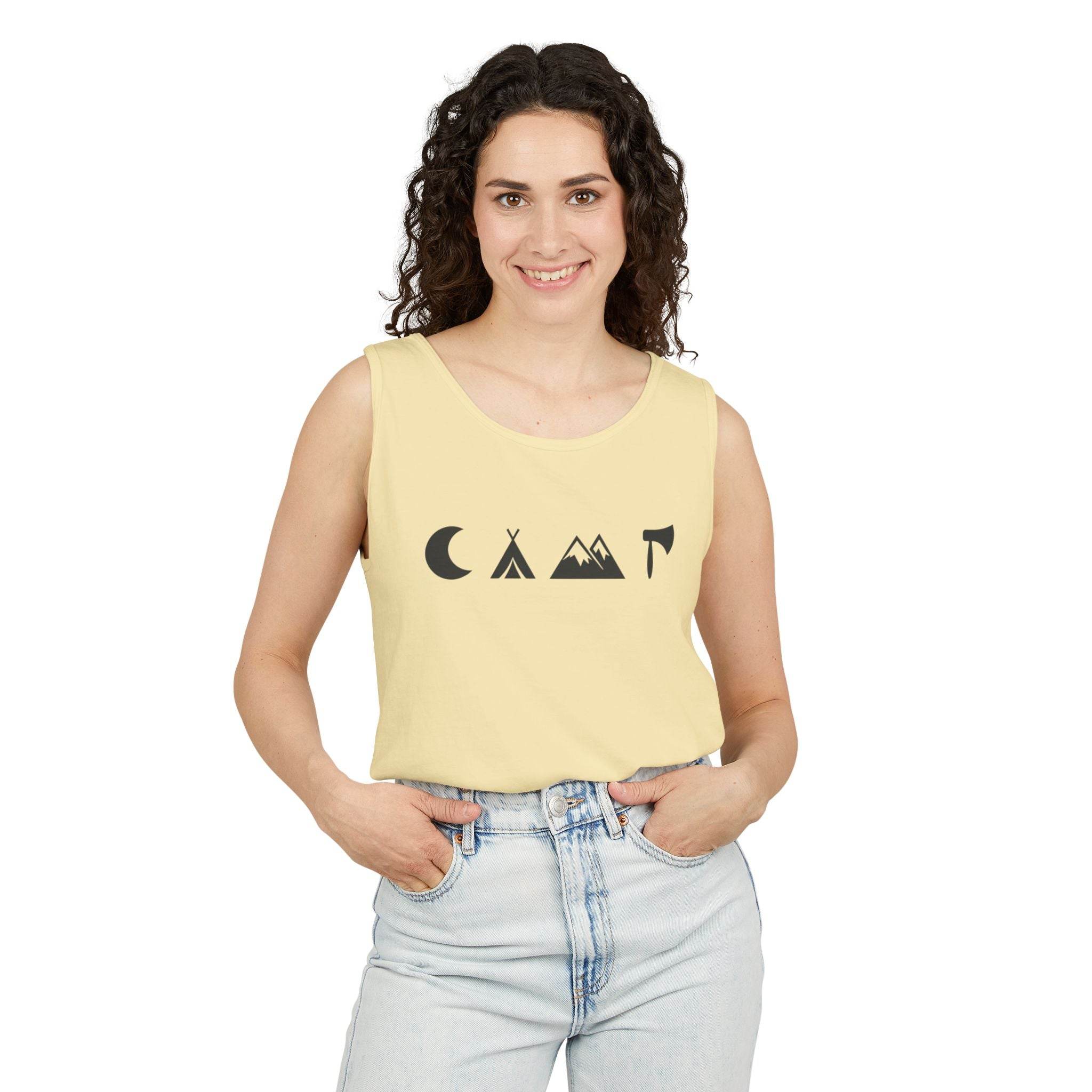 Smiling woman wearing pale yellow eco-friendly unisex tank top with minimalist camping icons and light wash jeans