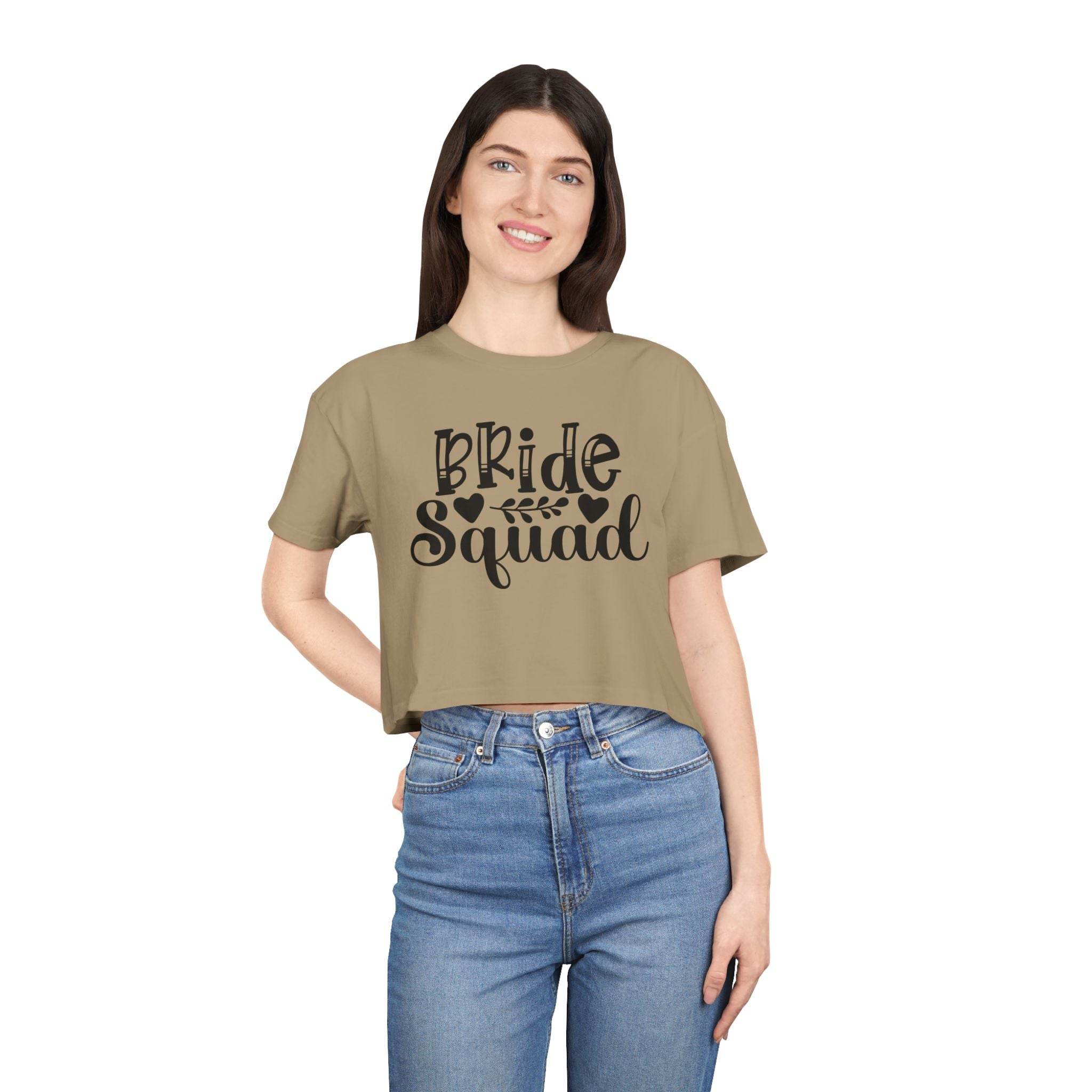 Woman model wearing eco-friendly bride squad crop top khaki with black Bride Squad print paired with high waisted jeans