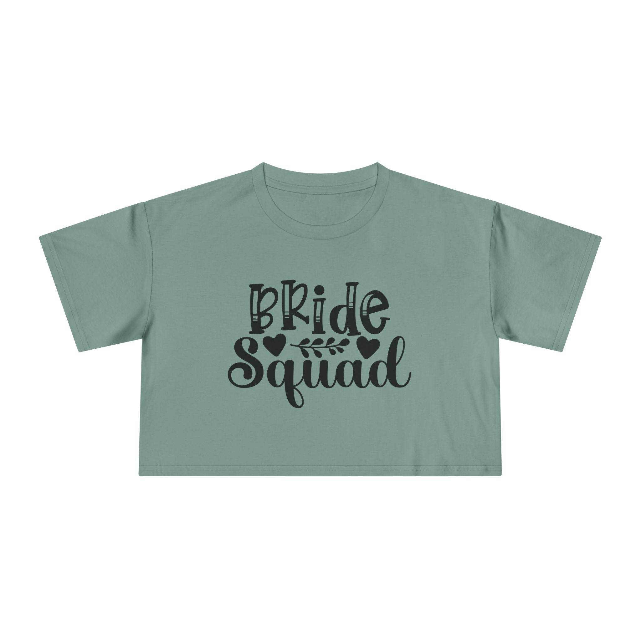 eco-friendly bride squad crop top in sage green with black Bride Squad script and leaf motif for bachelorette events