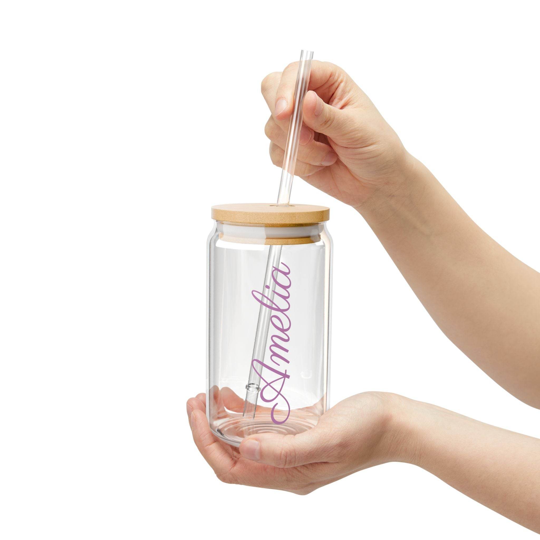 Printify personalized glass sipper with bamboo lid clear glass jar with bamboo lid straw and Amelia script name held in hands