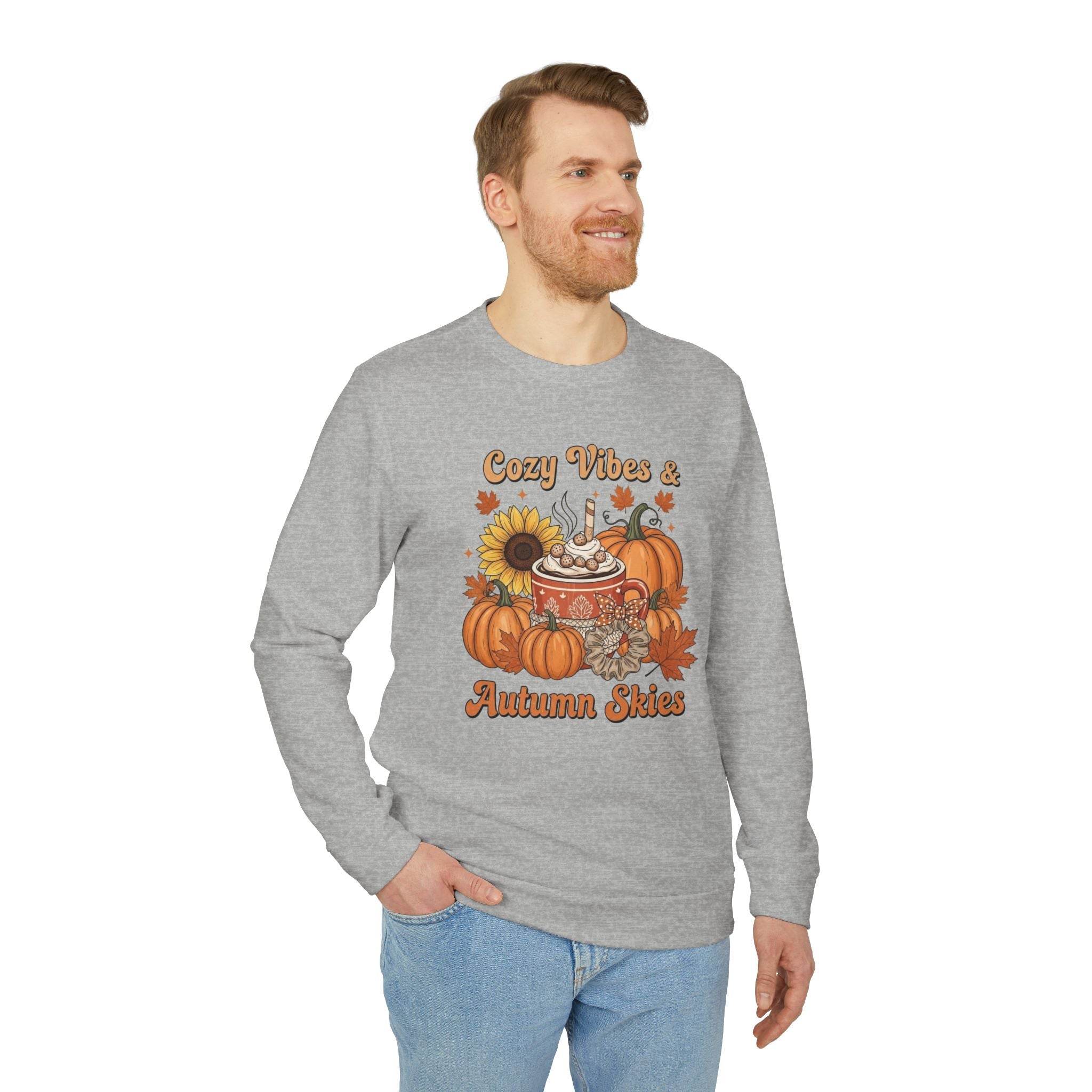 Man wearing grey long sleeve Printify sweatshirt with pumpkin sunflower fall graphic and text on eco-friendly autumn sweatshirt