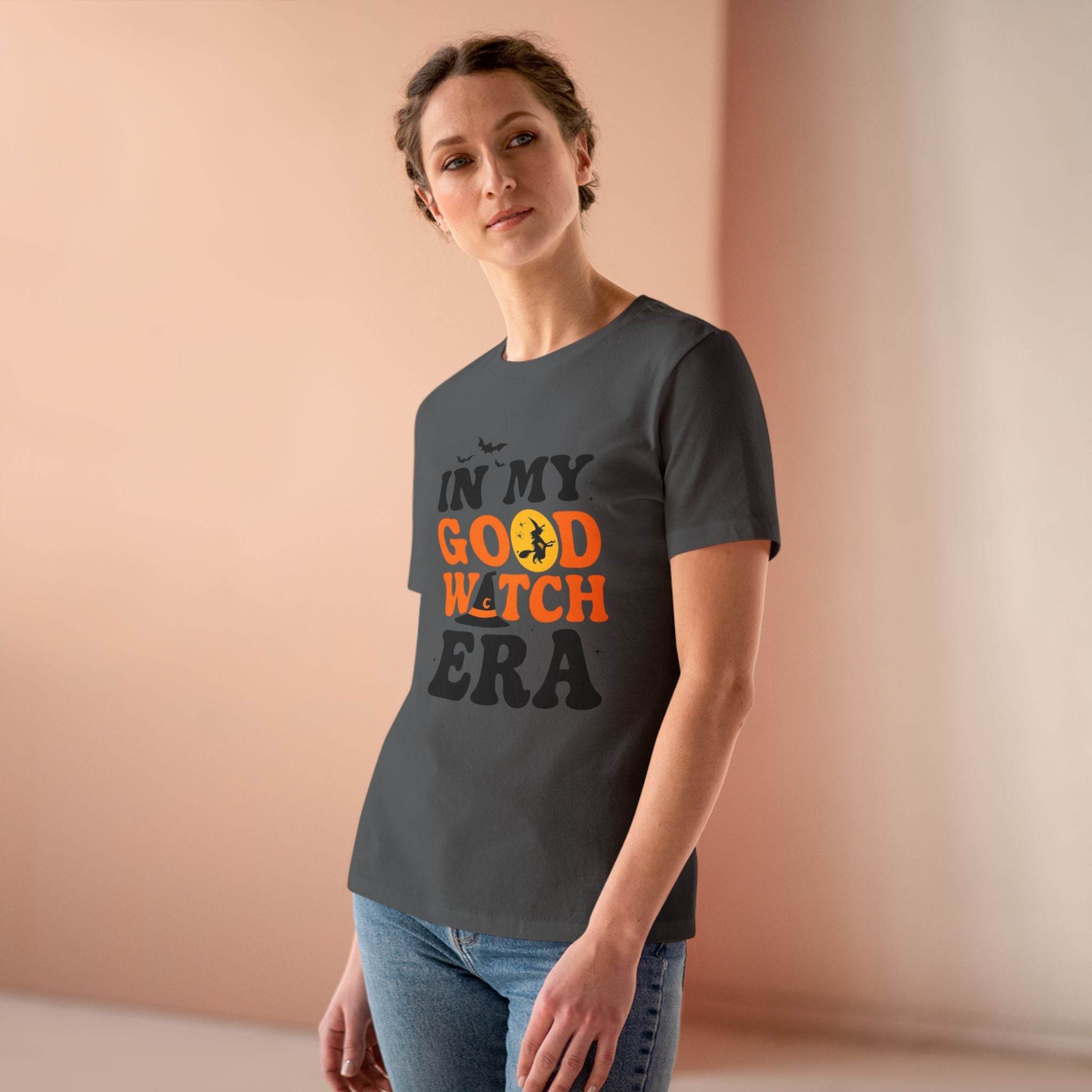 eco friendly halloween t shirt women model wearing charcoal gray tee with orange and black Good Witch print