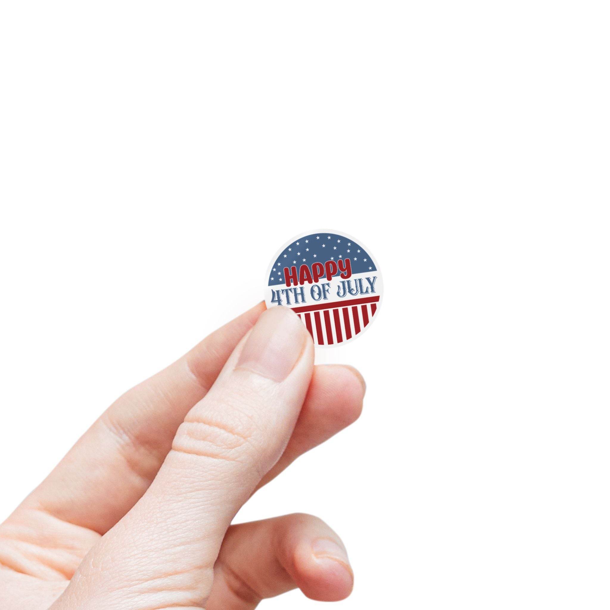 Hand holding a small round magnet with Happy 4th of July design eco-friendly 4th of July stickers by Printify