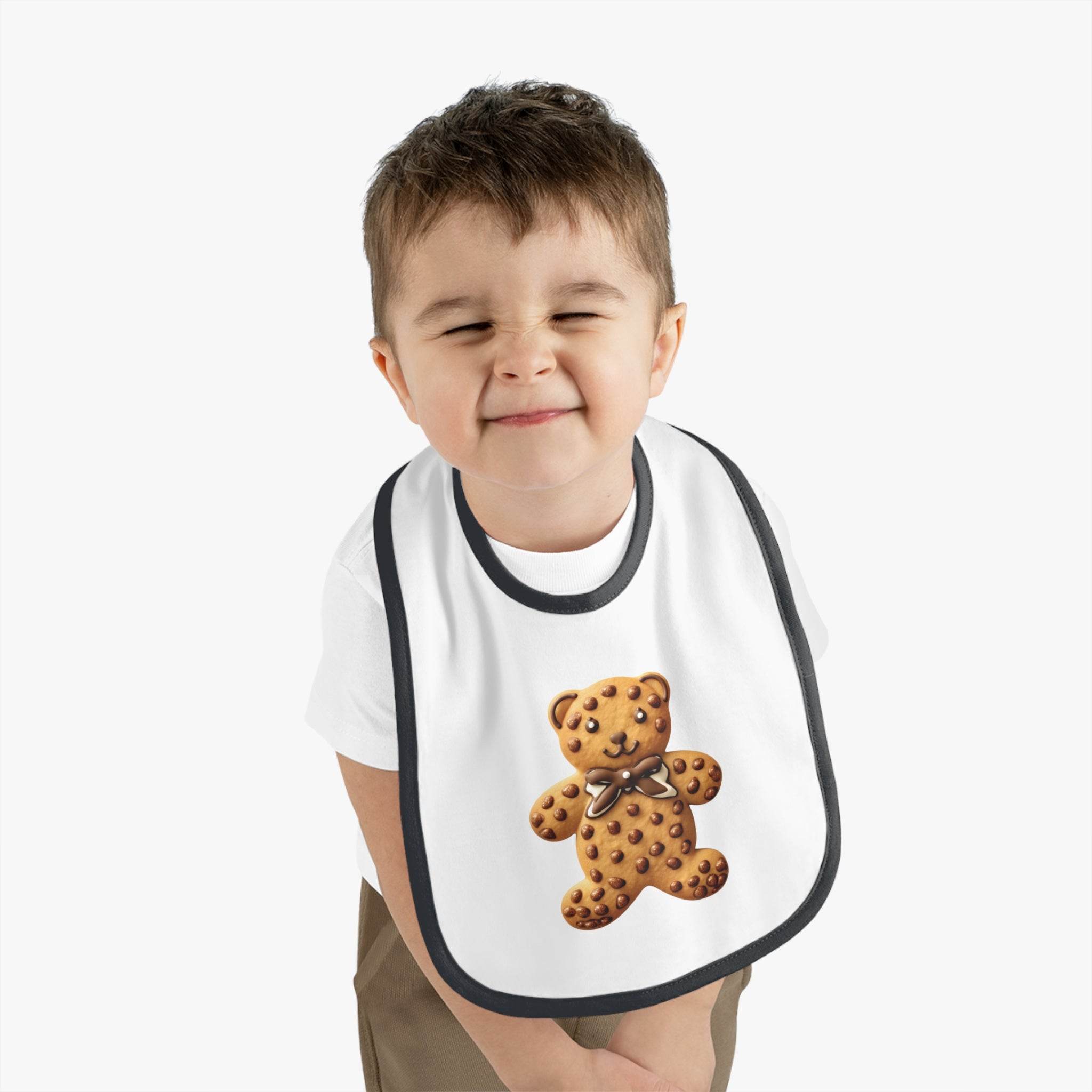 Toddler wearing Printify eco-friendly baby bib with a cute teddy bear design and black trim
