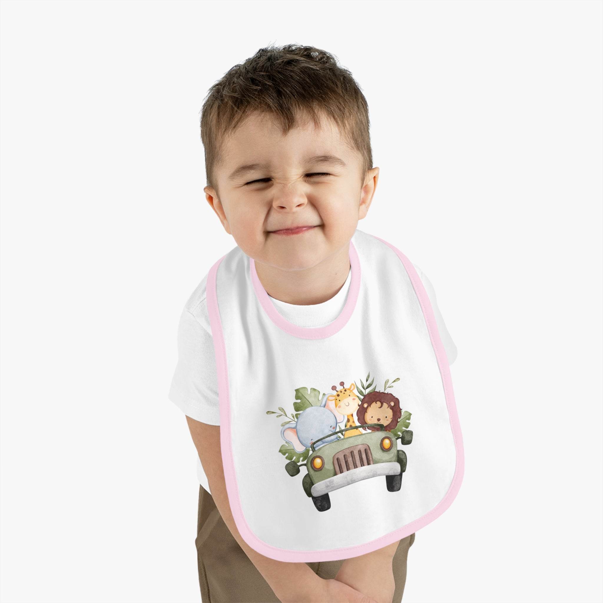 Child wearing Printify eco-friendly baby bib with animal design and pink trim