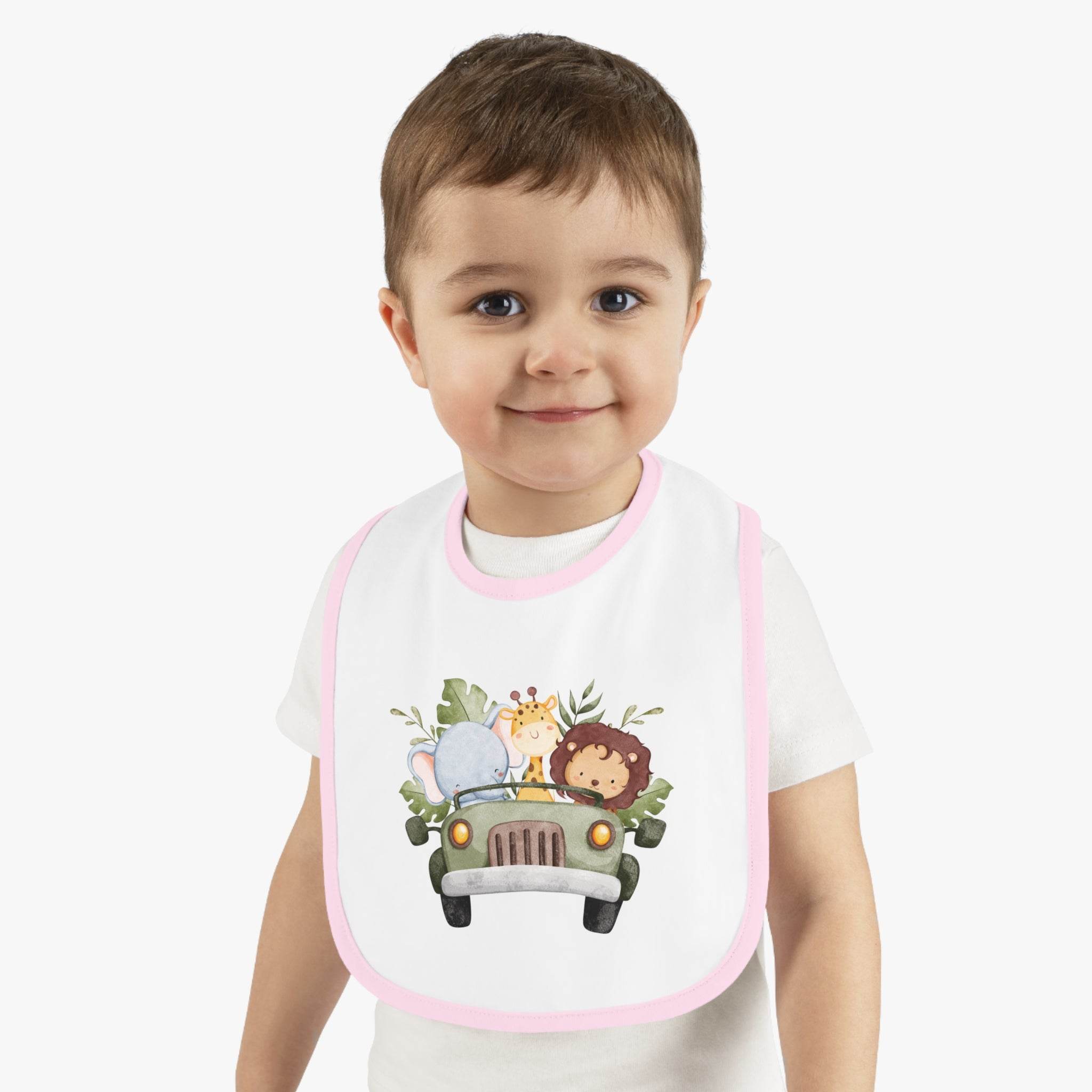 Toddler wearing a Printify eco-friendly baby bib with cute animal safari design and pink trim