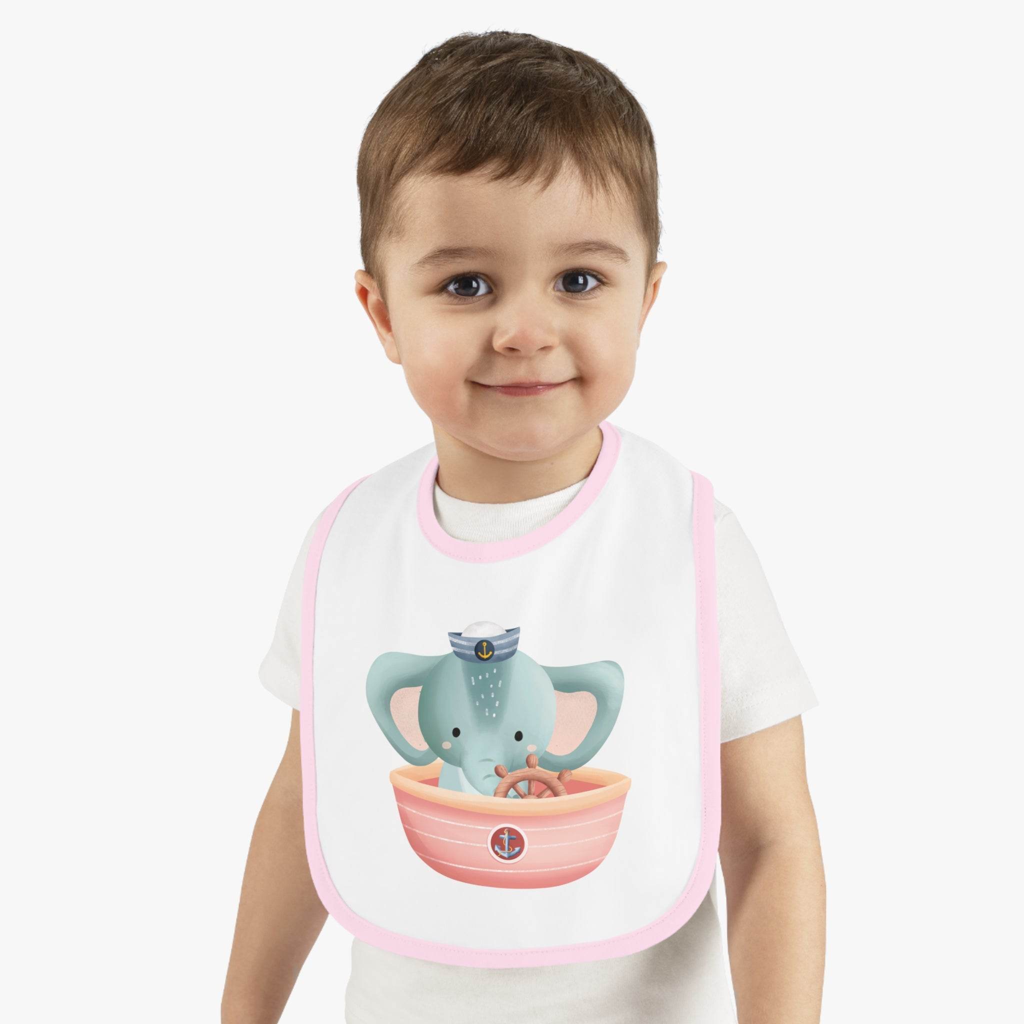 Toddler wearing Printify eco-friendly baby bib with pink trim and cute elephant nautical design
