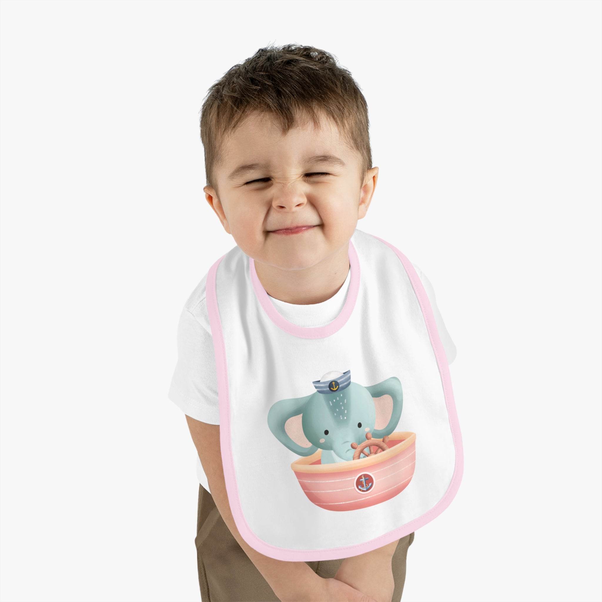 Printify eco-friendly baby bib with pink trim featuring a cute elephant in a sailor hat holding a boat
