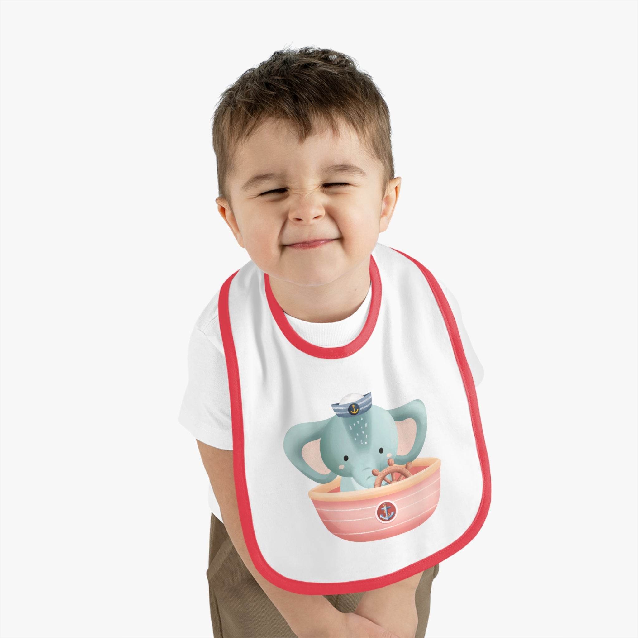 Toddler wearing eco-friendly baby bib with cute elephant sailor design by Printify
