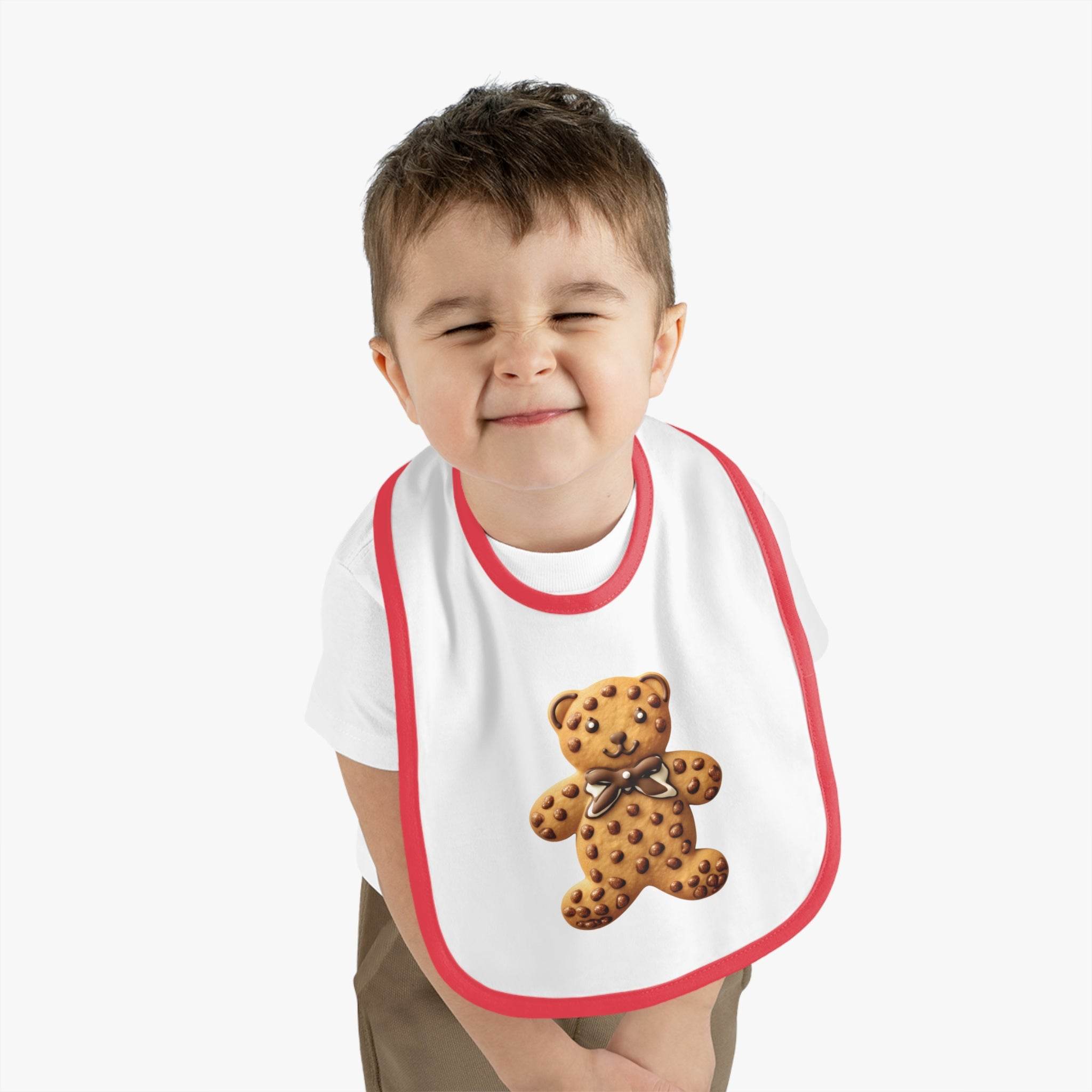 Toddler wearing Printify eco-friendly baby bib with red trim and teddy bear design on white background
