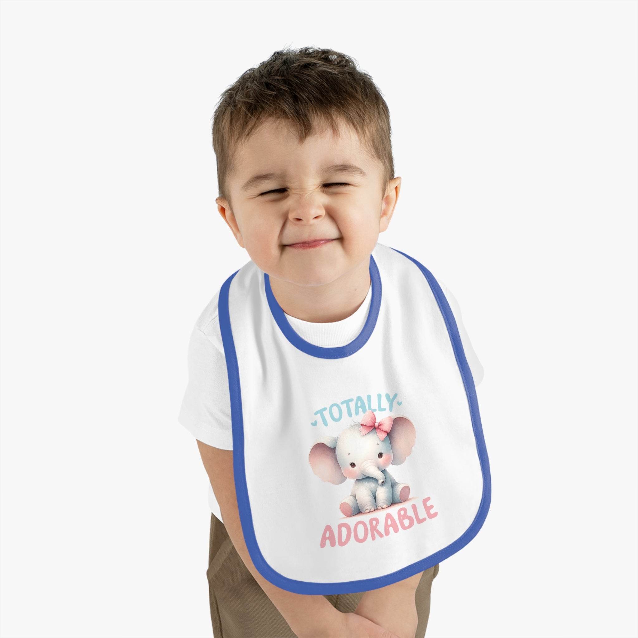 Toddler wearing Printify eco-friendly baby bib with cute elephant design and blue trim