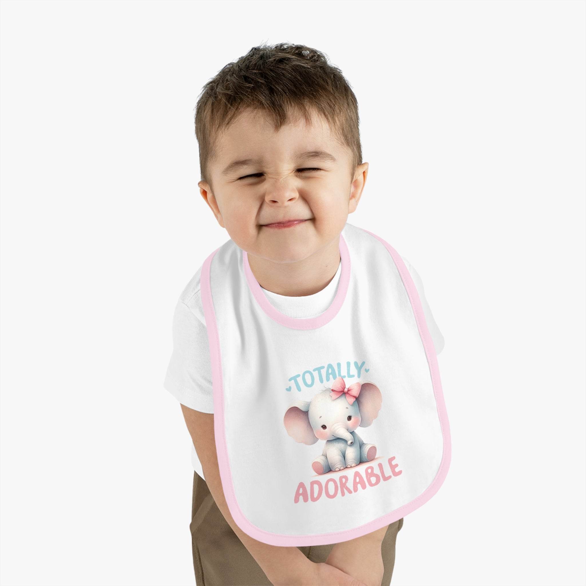 Child wearing Printify eco-friendly baby bib with cute elephant and totally adorable text