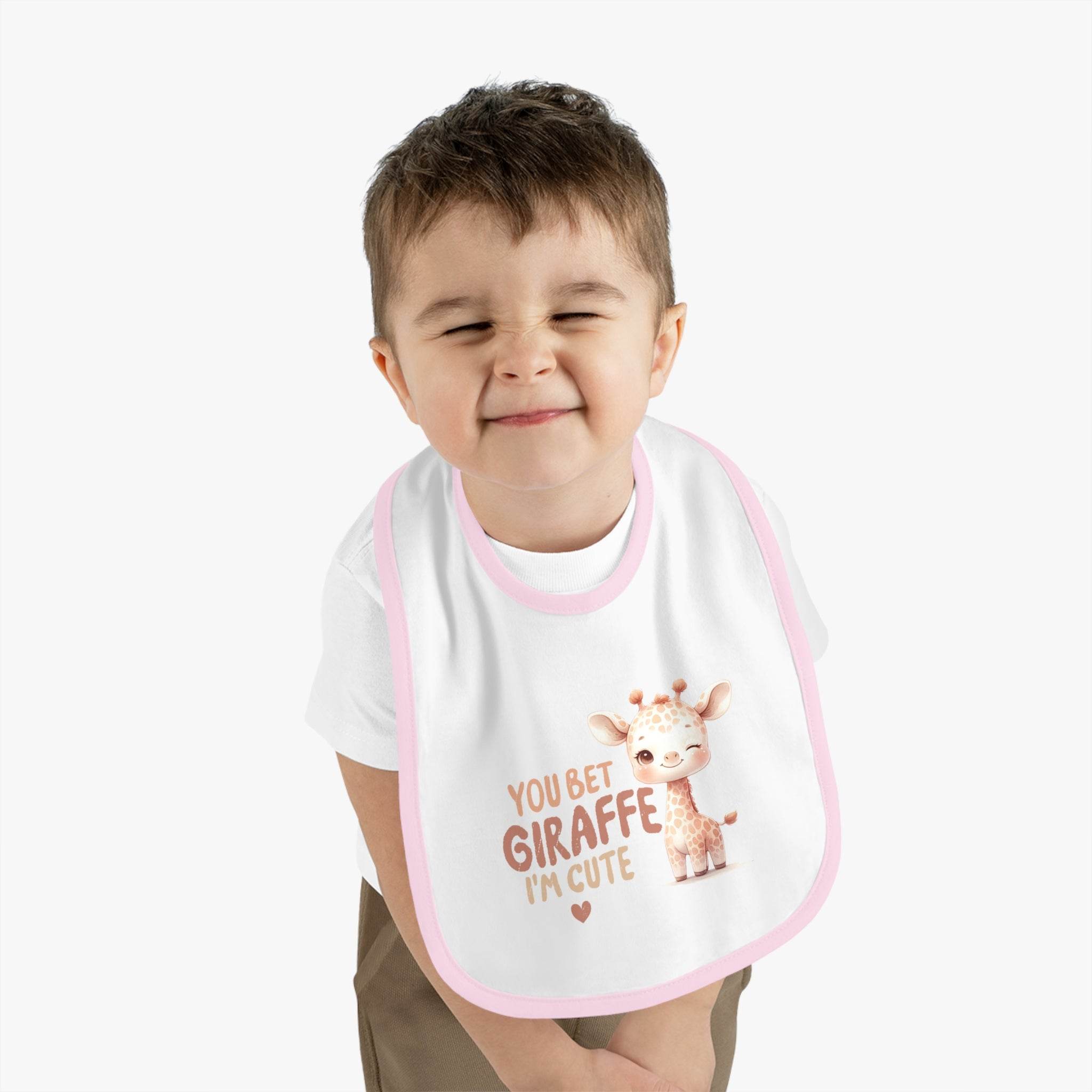 Child wearing Printify eco-friendly baby bib with cute giraffe design and pink trim