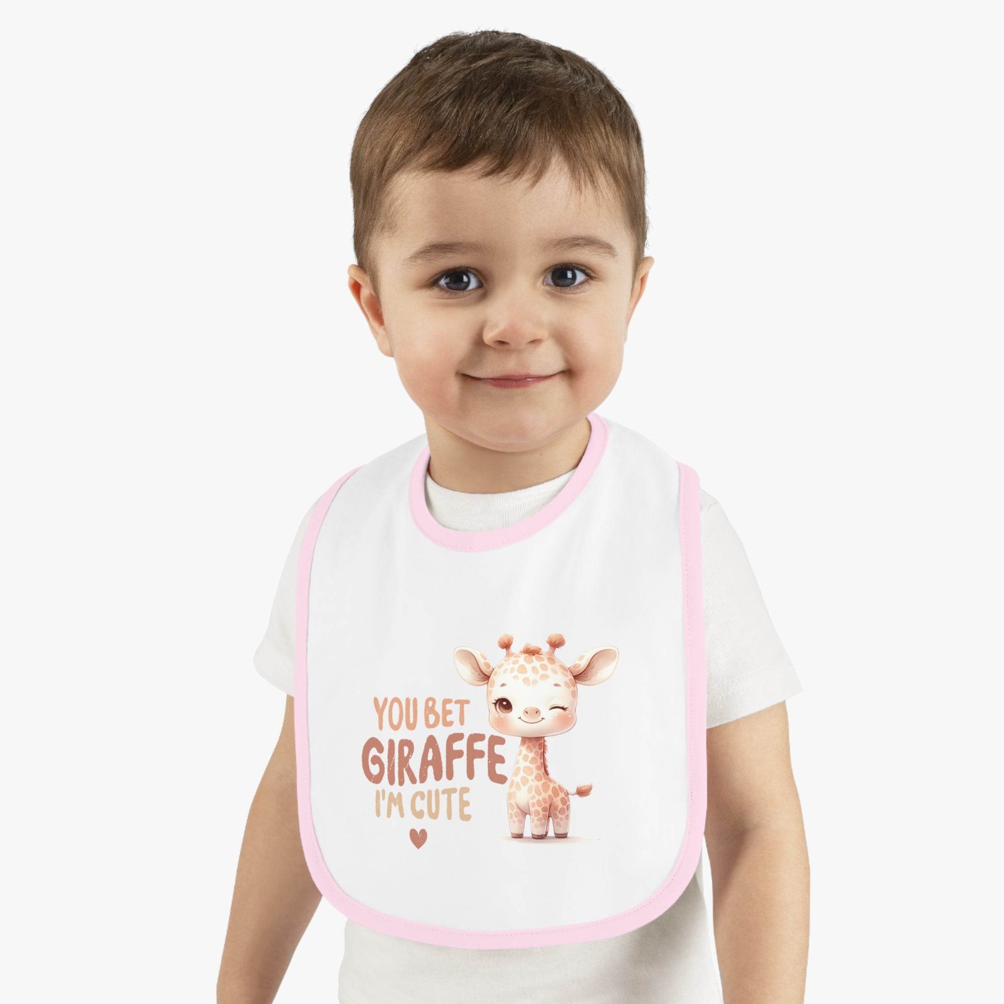 Toddler wearing Printify eco-friendly baby bib with pink trim and cute giraffe design