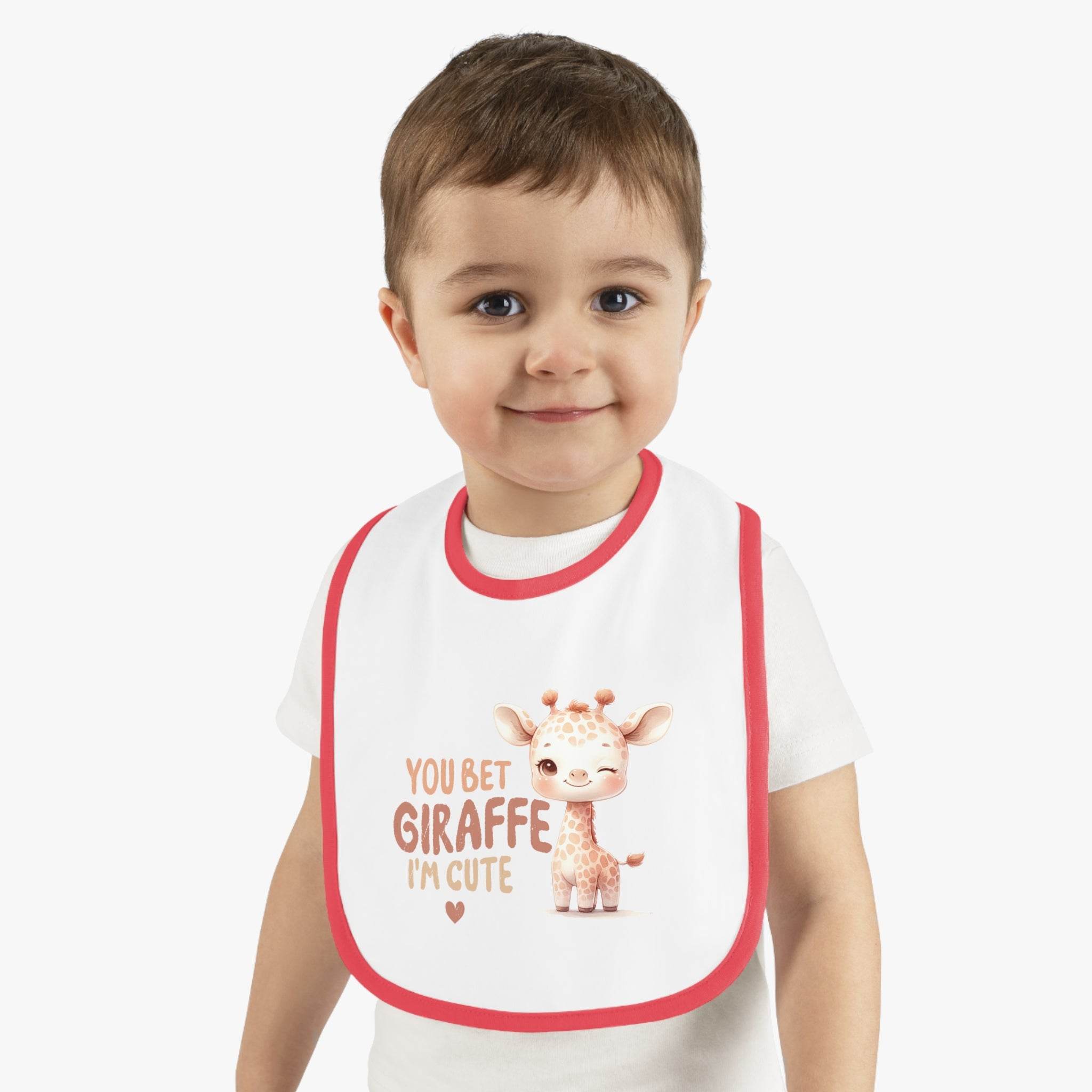 Child wearing an eco-friendly baby bib with a cute giraffe design and red trim by Printify
