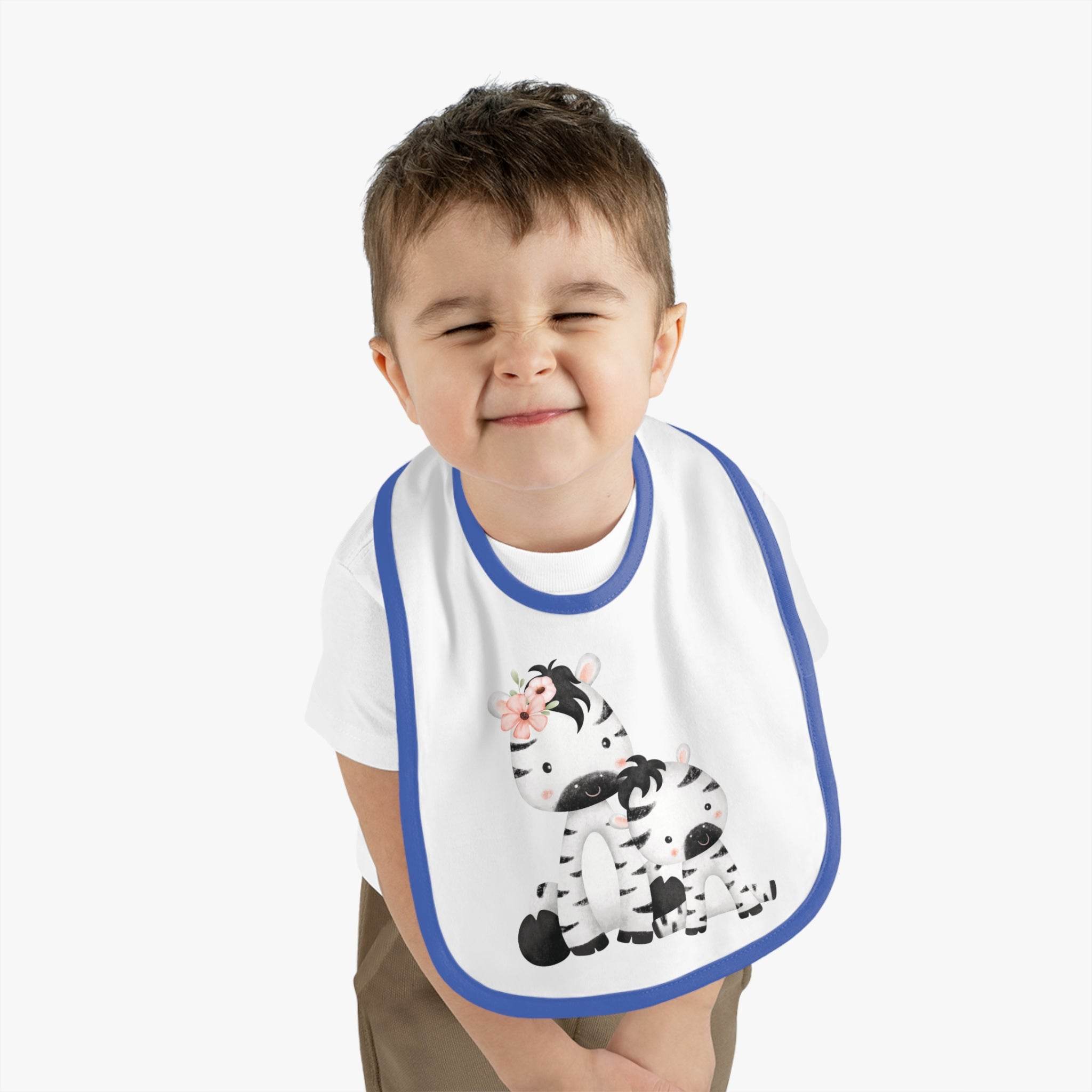 Toddler wearing Printify eco-friendly baby bib with cute zebra design and blue trim