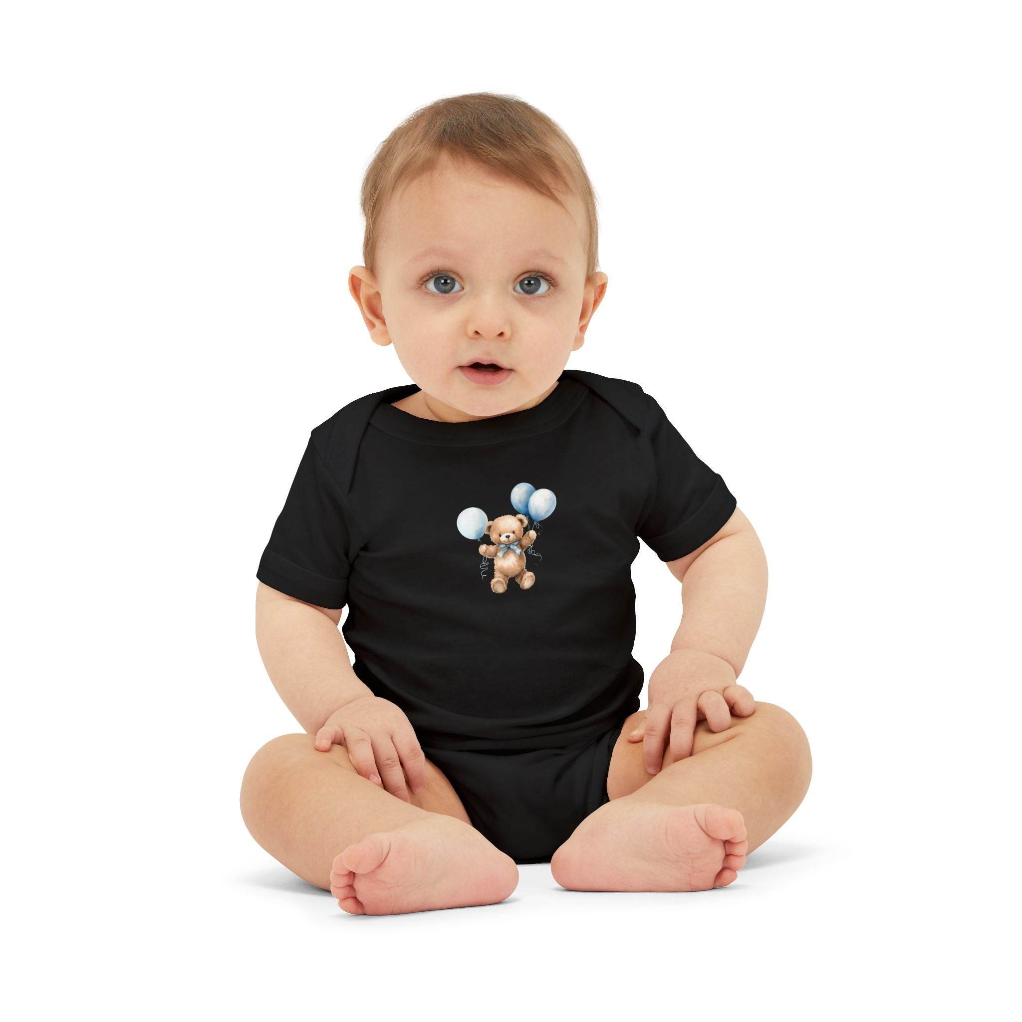 Baby wearing Printify black eco-friendly baby onesie with teddy bear and balloons design