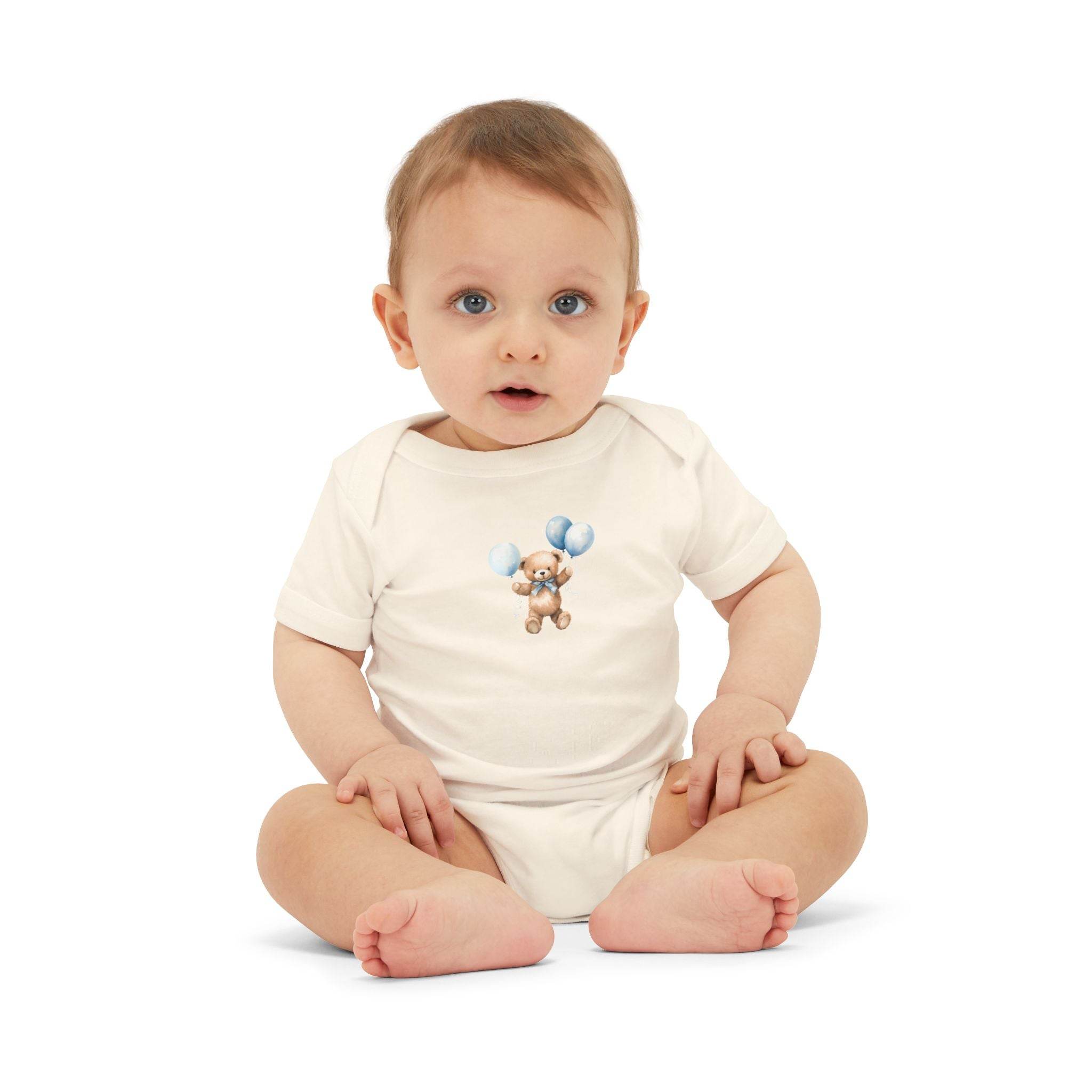 Baby wearing a Printify eco-friendly baby onesie with a teddy bear and blue balloons design