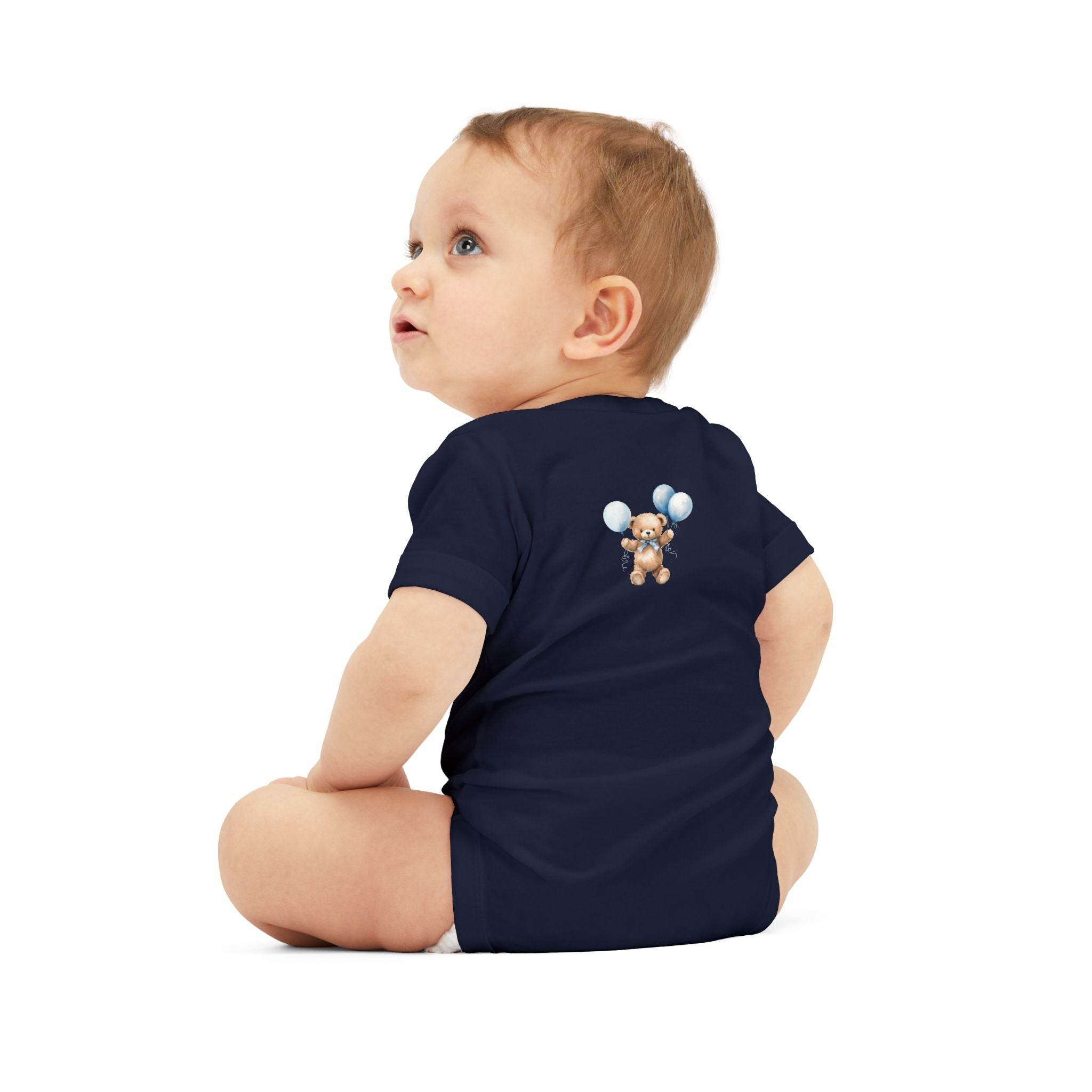 Baby wearing navy blue eco-friendly baby onesie by Printify with teddy bear and balloons design