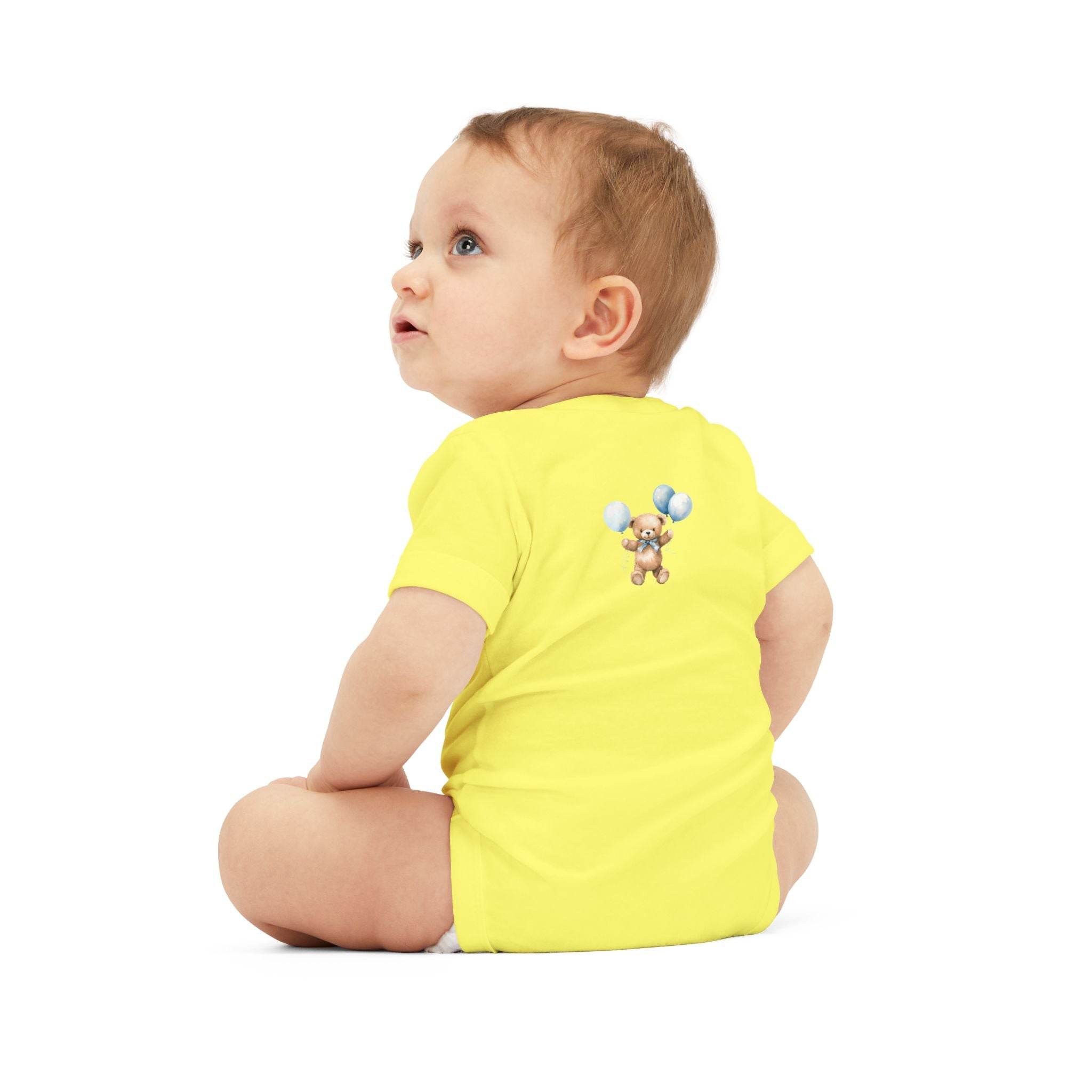 Baby wearing yellow eco-friendly baby onesie by Printify with teddy bear and balloons design