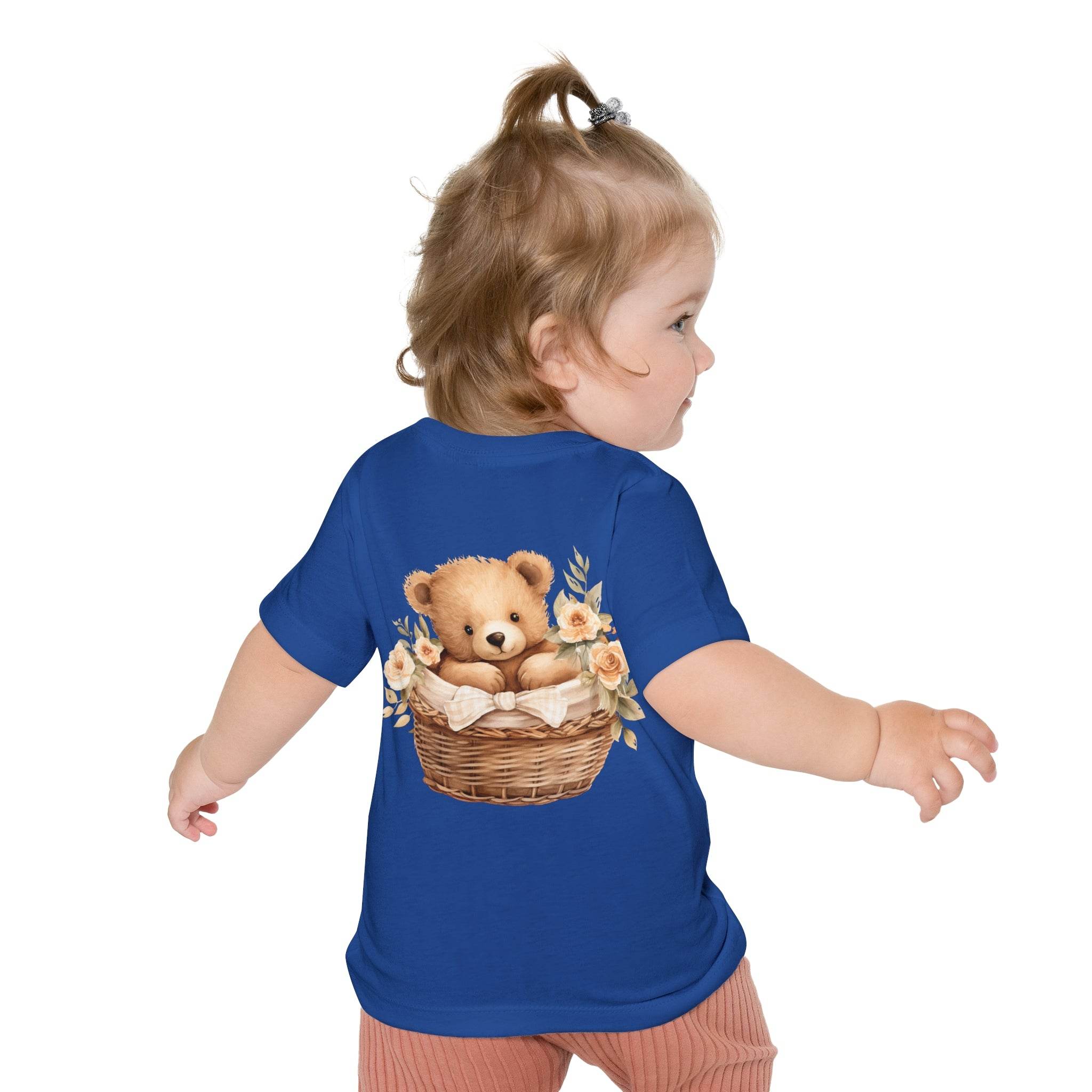 Toddler wearing blue eco-friendly baby t-shirt with teddy bear in basket and floral design on back
