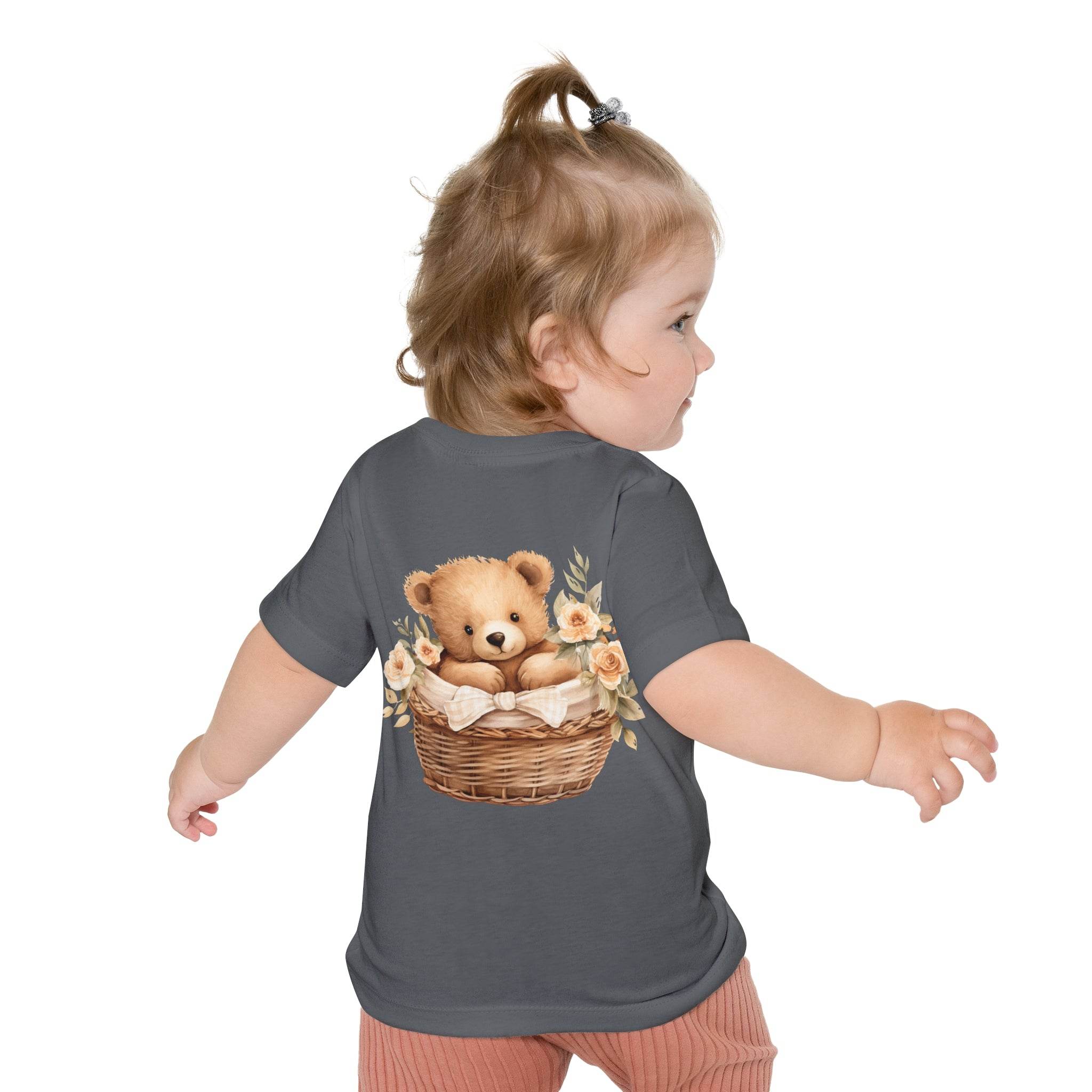Toddler wearing a gray eco-friendly baby t-shirt with a teddy bear in a basket design on the back