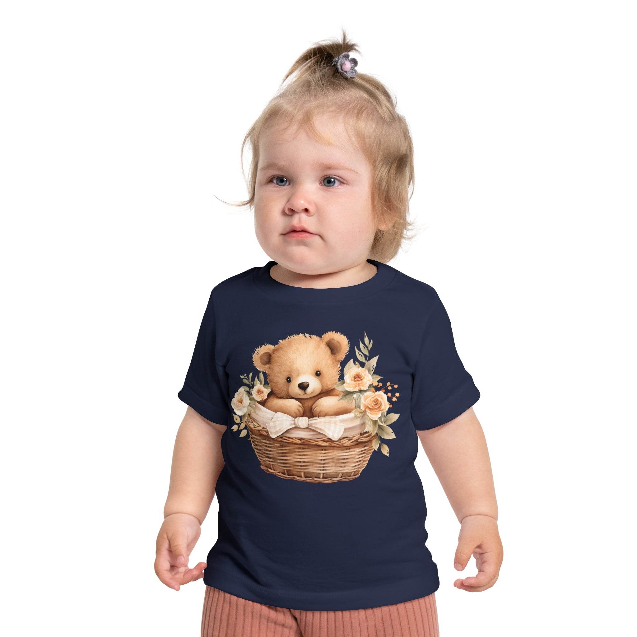 Toddler wearing navy Printify eco-friendly baby t-shirt with teddy bear and floral basket design