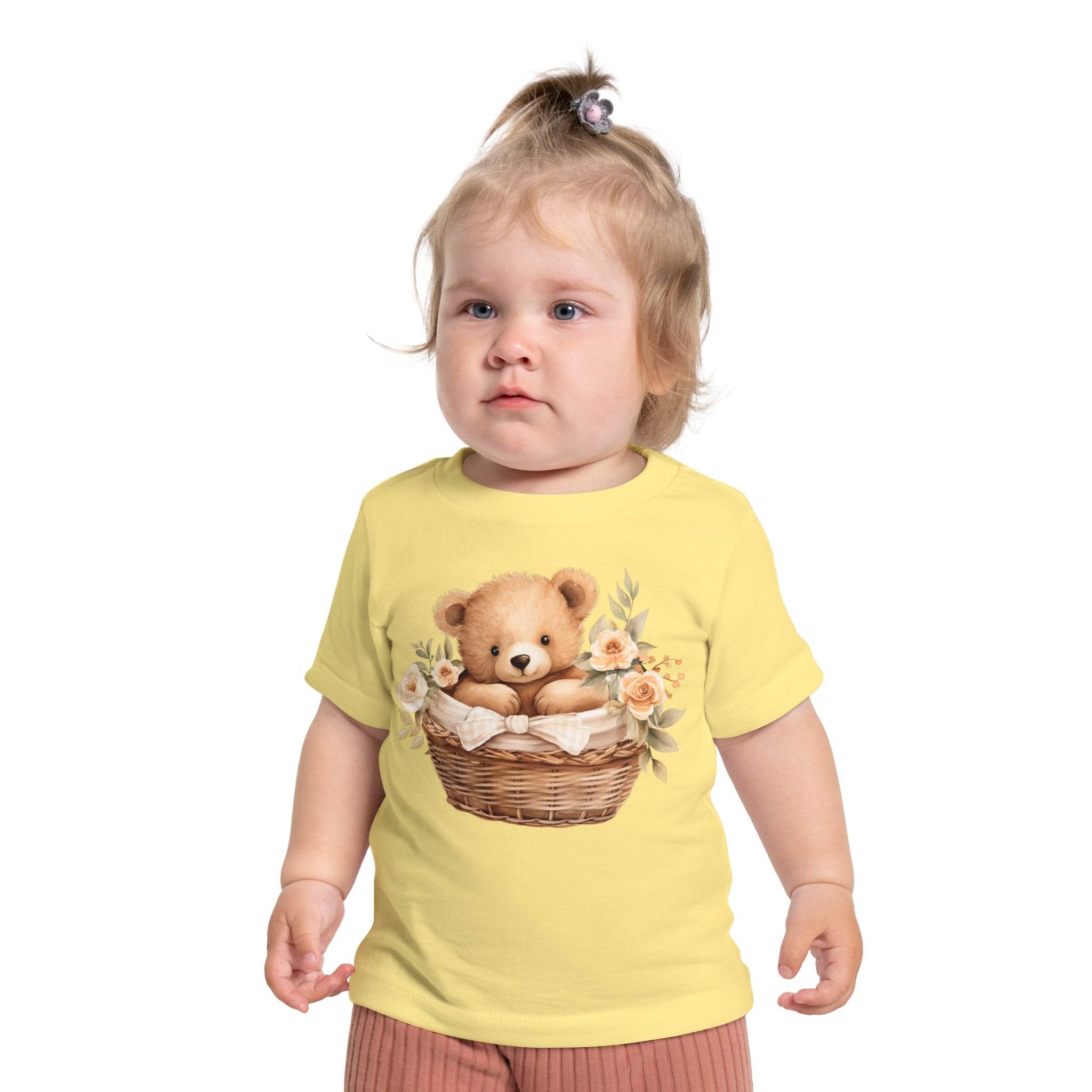 Toddler wearing Printify yellow eco-friendly baby t-shirt with cute teddy bear in basket design