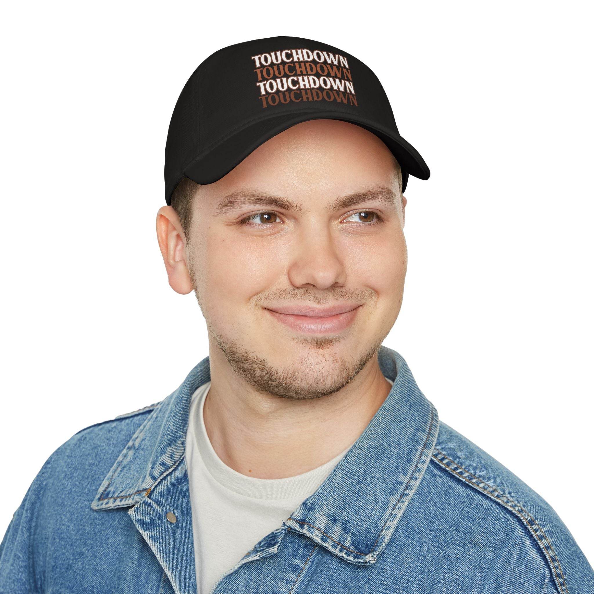 Man wearing black Printify eco-friendly baseball cap with repeated touchdown text and denim jacket