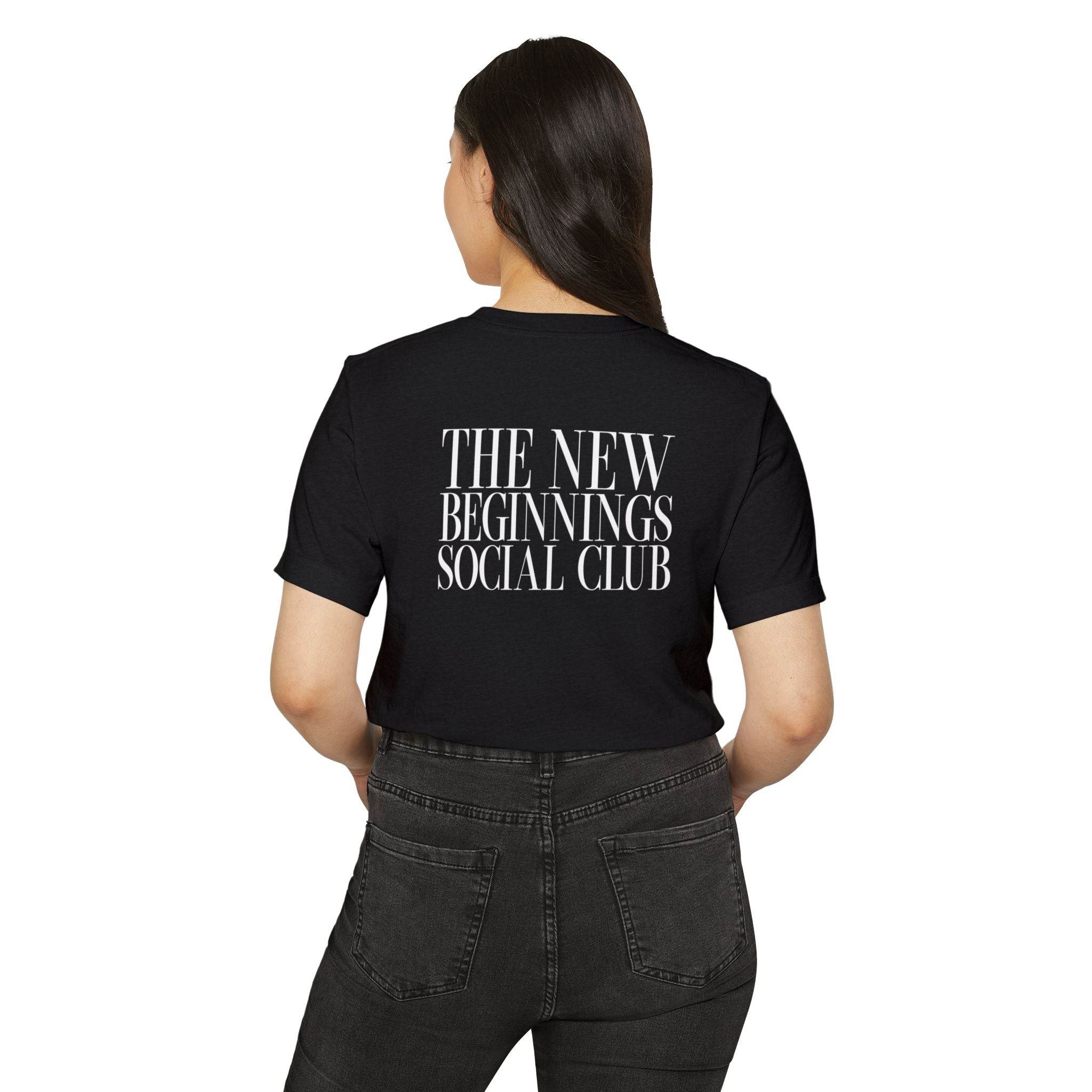 Printify black eco-friendly fashion tee with The New Beginnings Social Club text on back