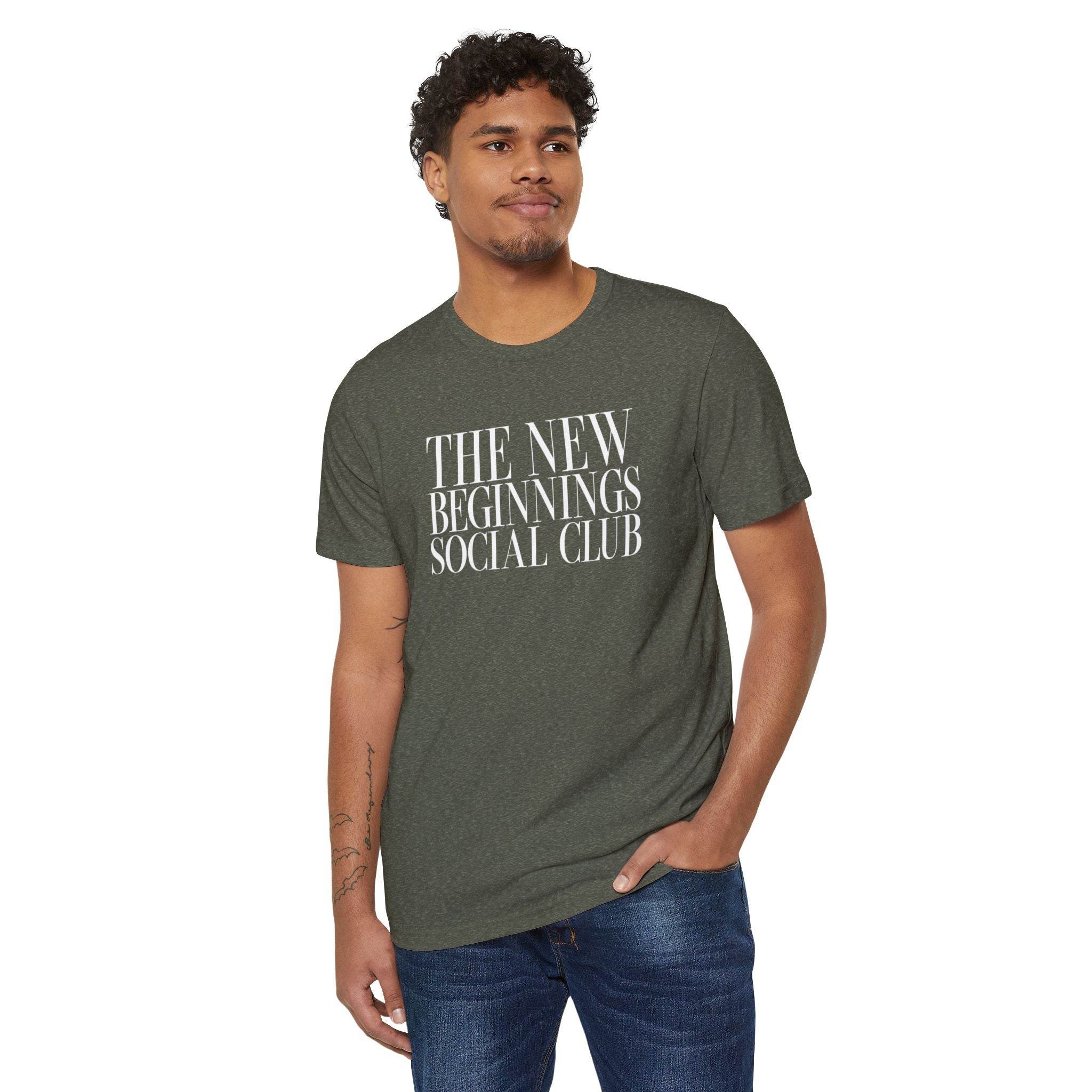 Printify eco-friendly fashion tee dark green with The New Beginnings Social Club text worn by male model
