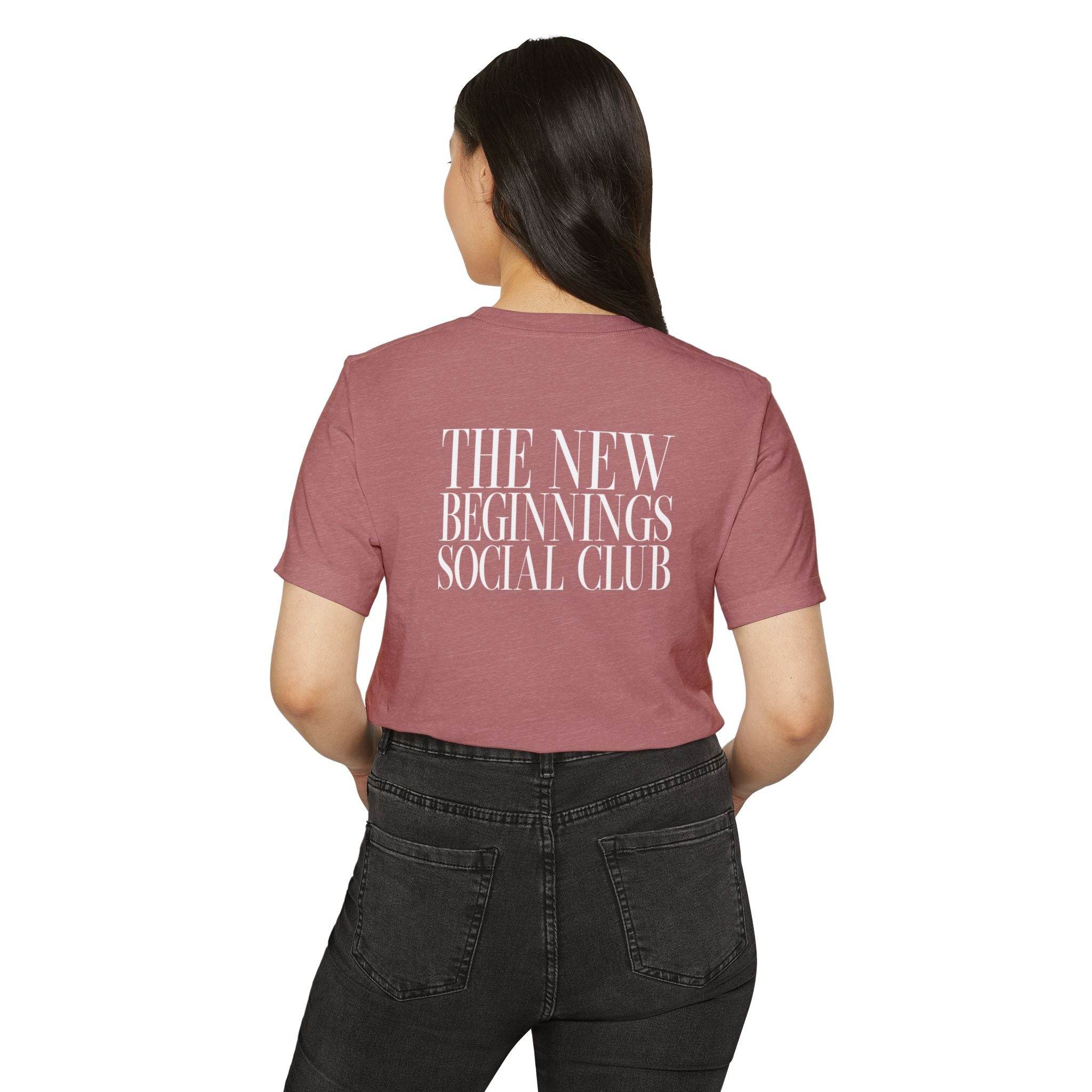 Printify eco-friendly fashion tee with The New Beginnings Social Club text on back in mauve