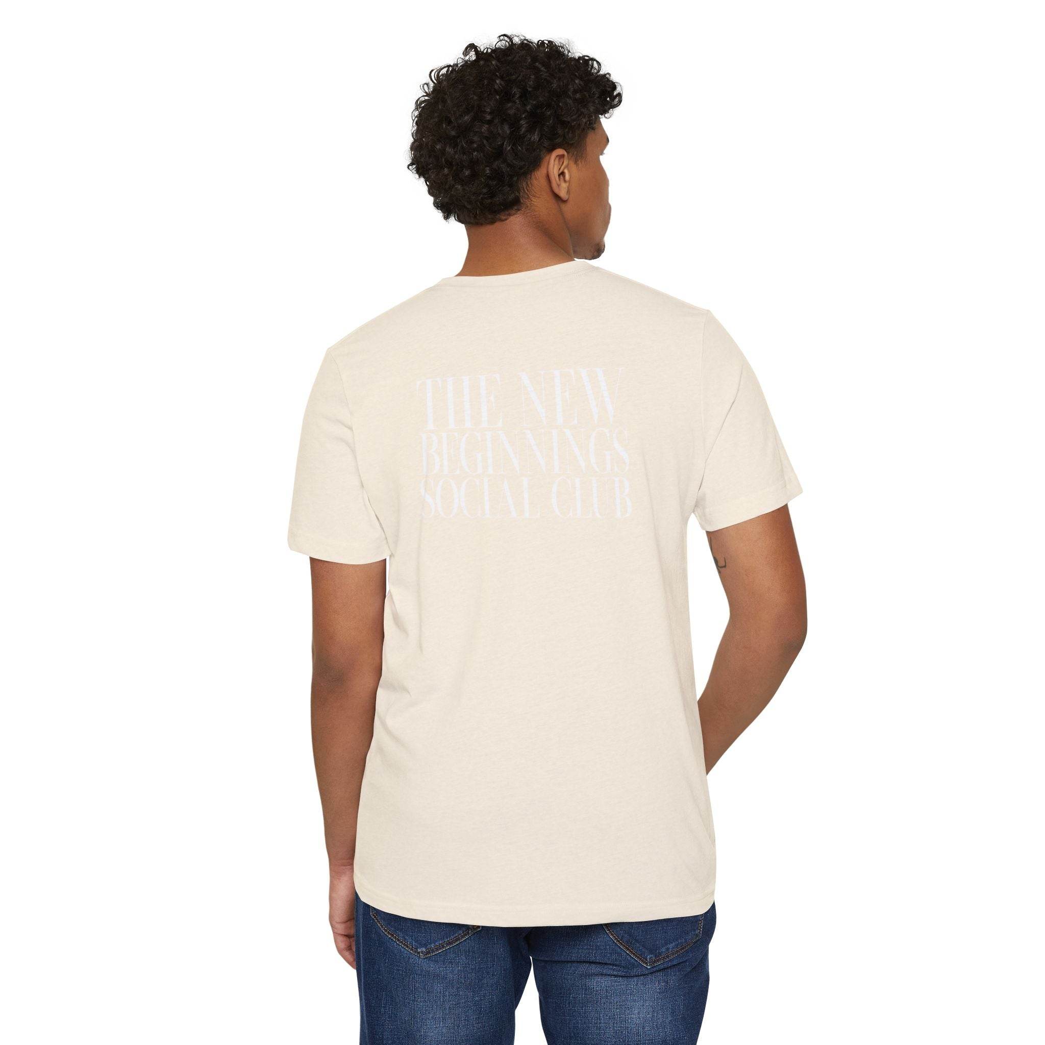 Printify eco-friendly fashion tee in beige with back graphic worn by male model in blue jeans