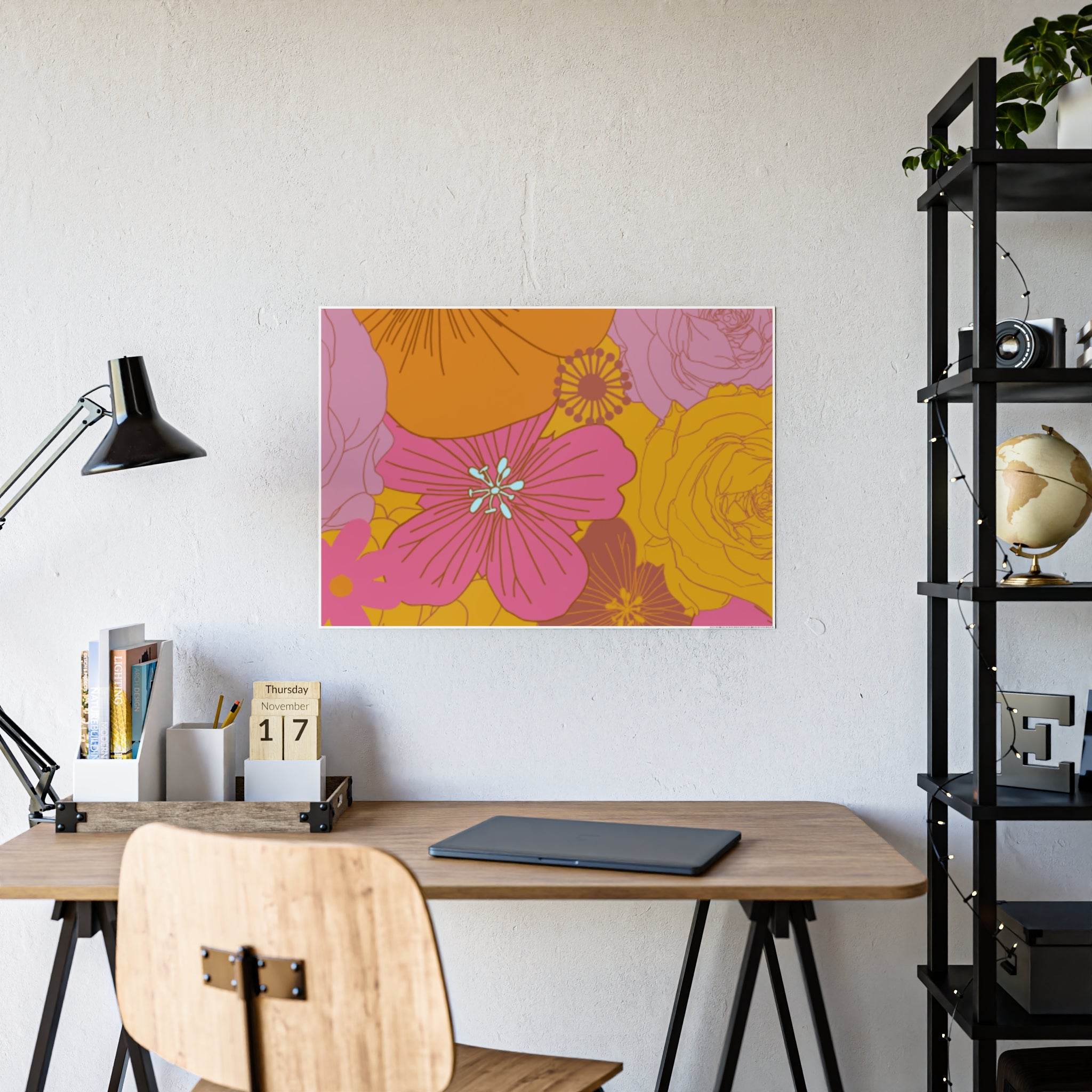 Eco-friendly flower posters with pink and yellow floral design displayed above a wooden desk workspace