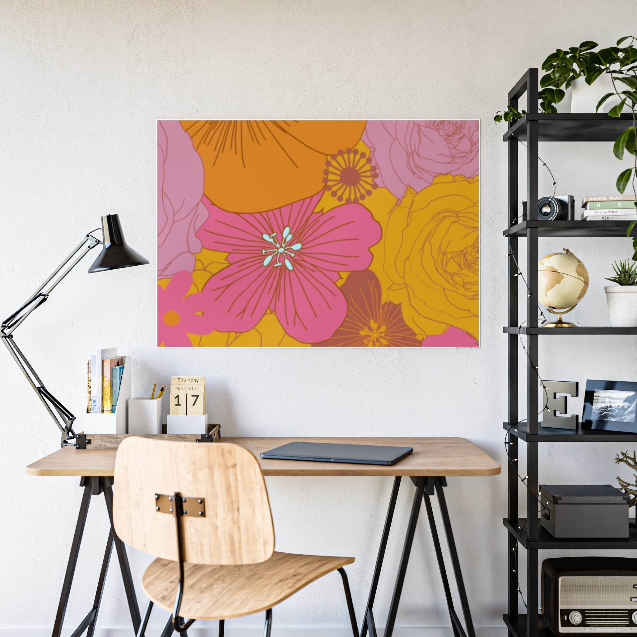 Eco-friendly flower posters with vibrant pink and orange floral design displayed above a modern wooden desk setup